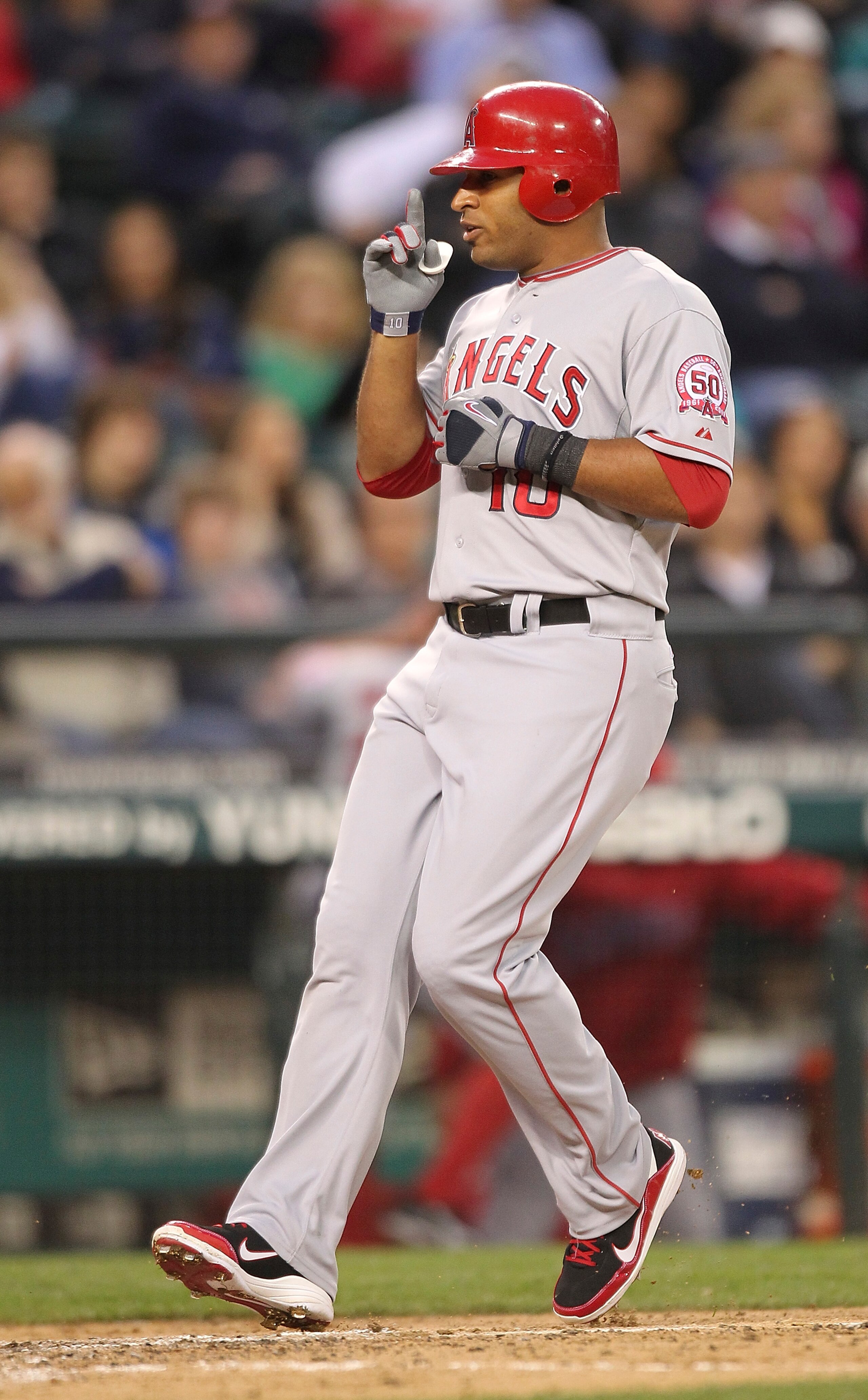 SEATTLE - JUNE 13:  Vernon Wells #10 of the Los Angeles Angels of Anaheim crosses home plate after hitting a two-run homer in the seventh inning against the Seattle Mariners at Safeco Field on June 13, 2011 in Seattle, Washington. (Photo by Otto Greule Jr