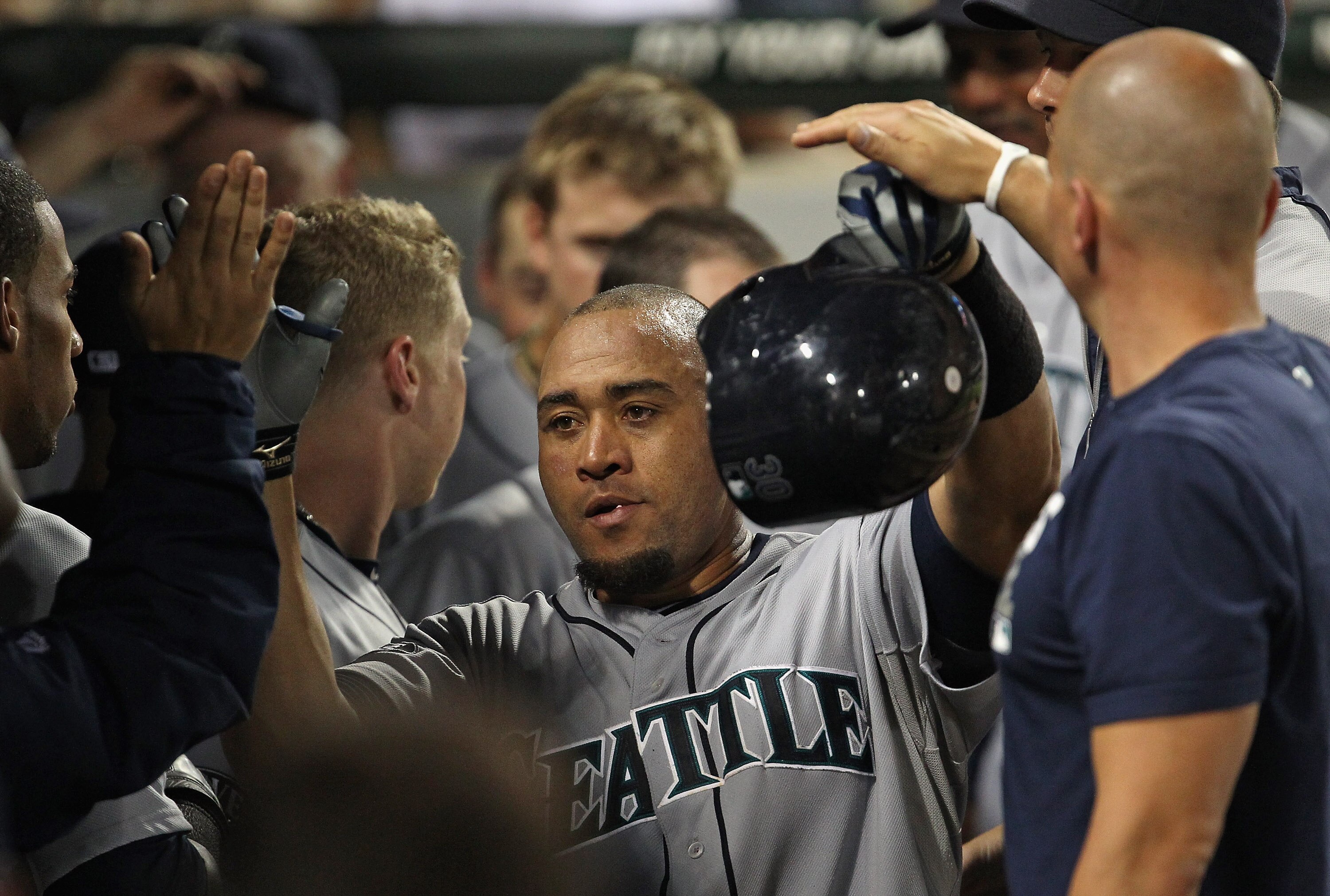 CHICAGO, IL - JUNE 08: Miguel Olivo #30 of the Seattle Mariners is congratulated by teammates in the dugout after hitting a solo home run in the 8th inning against the Chicago White Sox at U.S. Cellular Field on June 8, 2011 in Chicago, Illinois. The Mar CHICAGO, IL - JUNE 08: Miguel Olivo #30 of the Seattle Mariners is congratulated by teammates in the dugout after hitting a solo home run in the 8th inning against the Chicago White Sox at U.S. Cellular Field on June 8, 2011 in Chicago, Illinois. The Mar