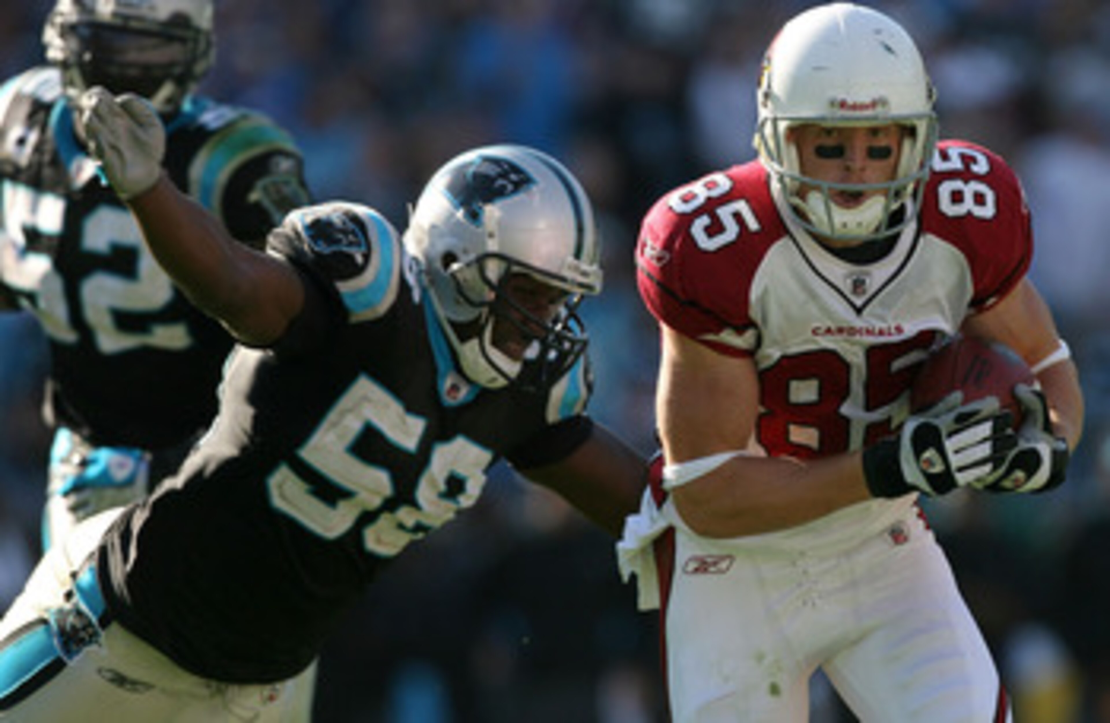 CHARLOTTE, NC - OCTOBER 26: Jerheme Urban #85 of the Arizona Cardinals tries to run away from Thomas Davis #58 of the Carolina Panthers during their game on October 26, 2008 at Bank of America Stadium in Charlotte, North Carolina. (Photo by Streeter Le CHARLOTTE, NC - OCTOBER 26: Jerheme Urban #85 of the Arizona Cardinals tries to run away from Thomas Davis #58 of the Carolina Panthers during their game on October 26, 2008 at Bank of America Stadium in Charlotte, North Carolina. (Photo by Streeter Le