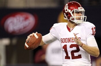 ARLINGTON, TX - DECEMBER 04:  Quarterback Landry Jones #12 of the Oklahoma Sooners drops back to pass against the Nebraska Cornhuskers during the Big 12 Championship at Cowboys Stadium on December 4, 2010 in Arlington, Texas.  (Photo by Ronald Martinez/Ge