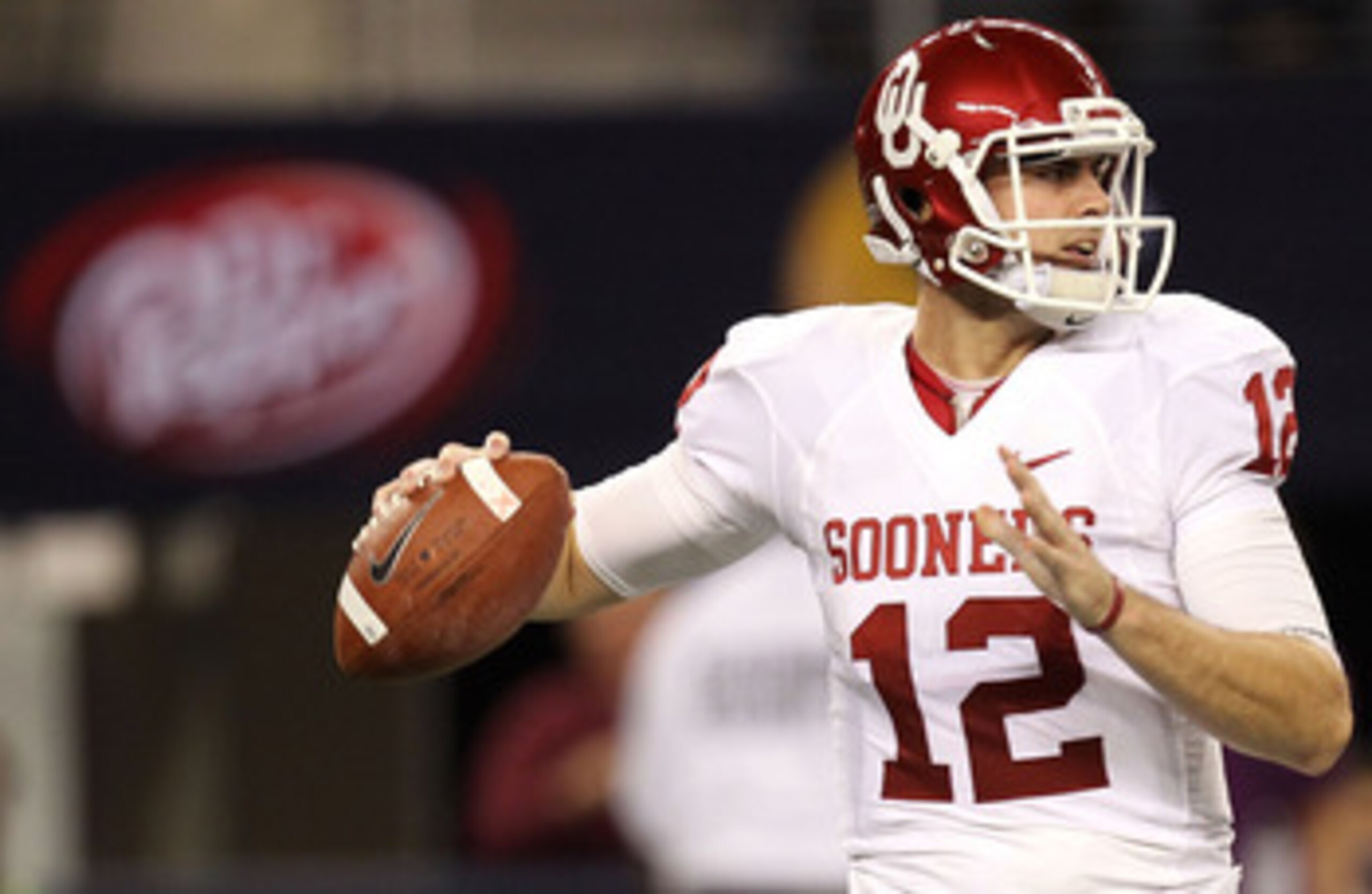 ARLINGTON, TX - DECEMBER 04:  Quarterback Landry Jones #12 of the Oklahoma Sooners drops back to pass against the Nebraska Cornhuskers during the Big 12 Championship at Cowboys Stadium on December 4, 2010 in Arlington, Texas.  (Photo by Ronald Martinez/Ge