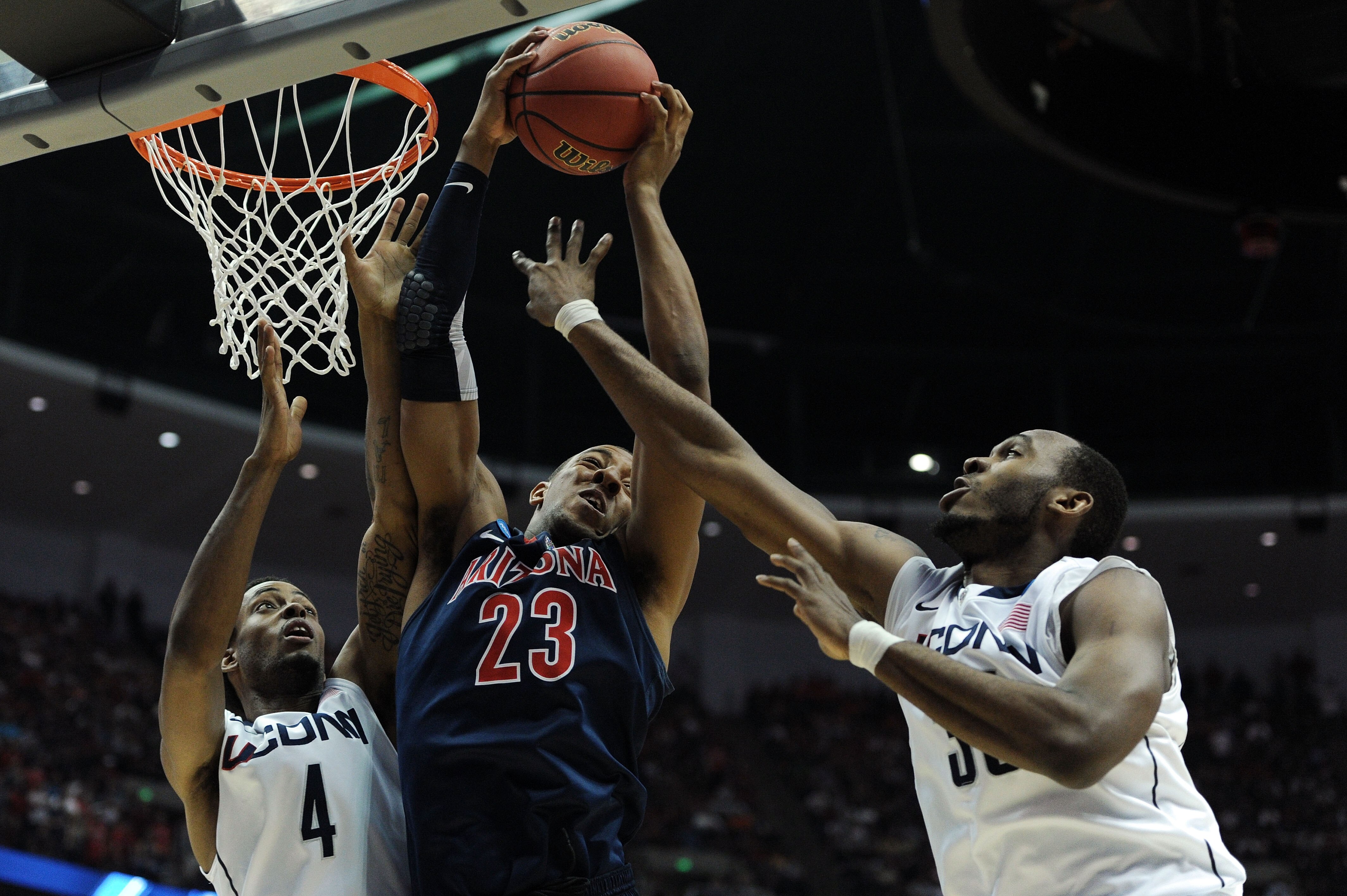 ANAHEIM, CA - MARCH 26: Derrick Williams #23 of the Arizona Wildcats goes up for a rebound against Jamal Coombs-McDaniel #4 and Charles Okwandu #35 of the Connecticut Huskies during the west regional final of the 2011 NCAA men's basketball tournament at ANAHEIM, CA - MARCH 26: Derrick Williams #23 of the Arizona Wildcats goes up for a rebound against Jamal Coombs-McDaniel #4 and Charles Okwandu #35 of the Connecticut Huskies during the west regional final of the 2011 NCAA men's basketball tournament at