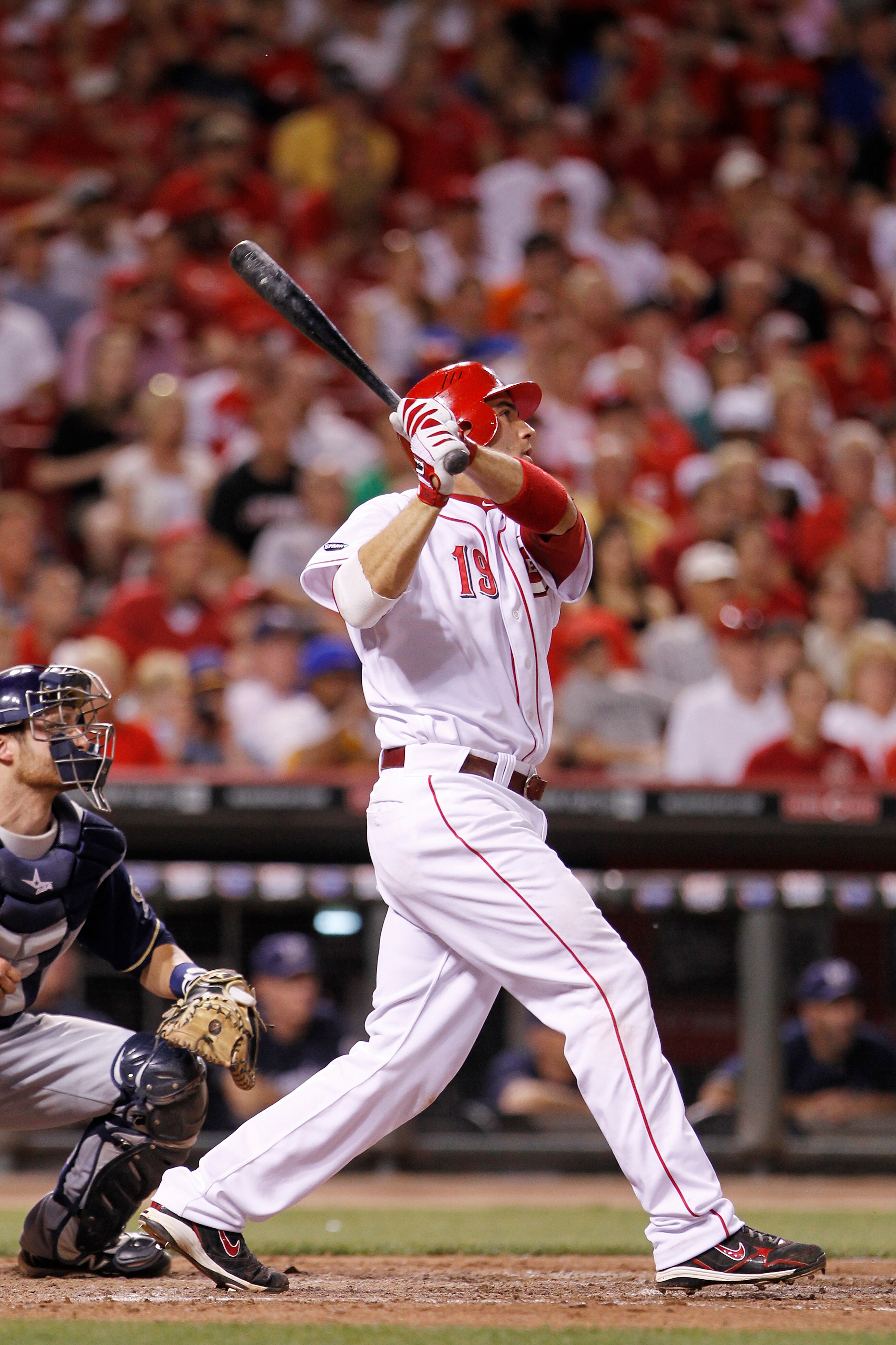 CINCINNATI, OH - JUNE 1: Joey Votto #19 of the Cincinnati Reds follows through on a two-run home run in the eighth inning against the Milwaukee Brewers at Great American Ball Park on June 1, 2011 in Cincinnati, Ohio. The Reds defeated the Brewers 4-3. (Ph