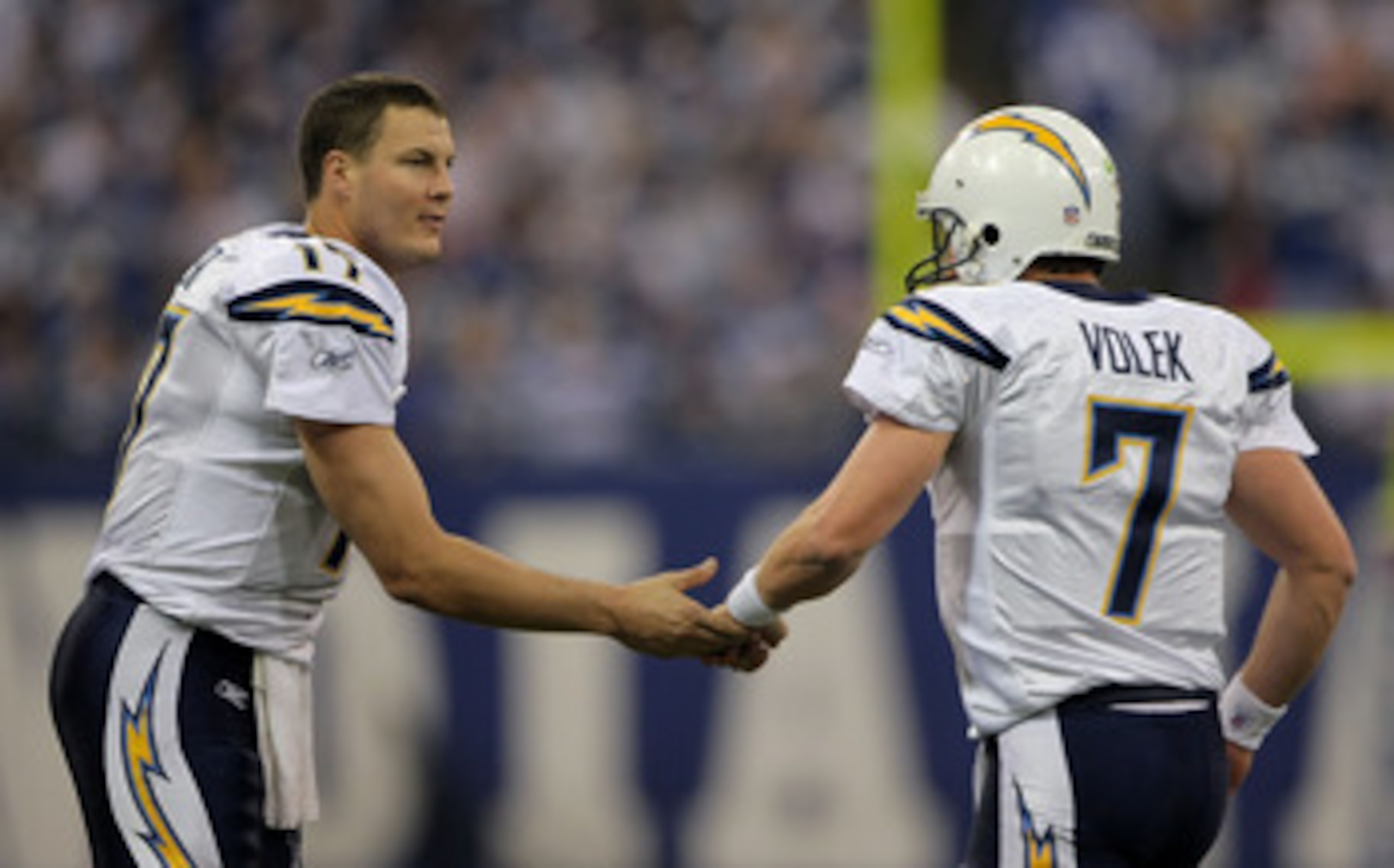 INDIANAPOLIS - JANUARY 13:  Philip Rivers #17 of the San Diego Chargers congratulates Billy Volek #7 after Volek scored touchdown on a 1-yard run in the fourth quarter against the Indianapolis Colts during their AFC Divisional Playoff game at the RCA Dome