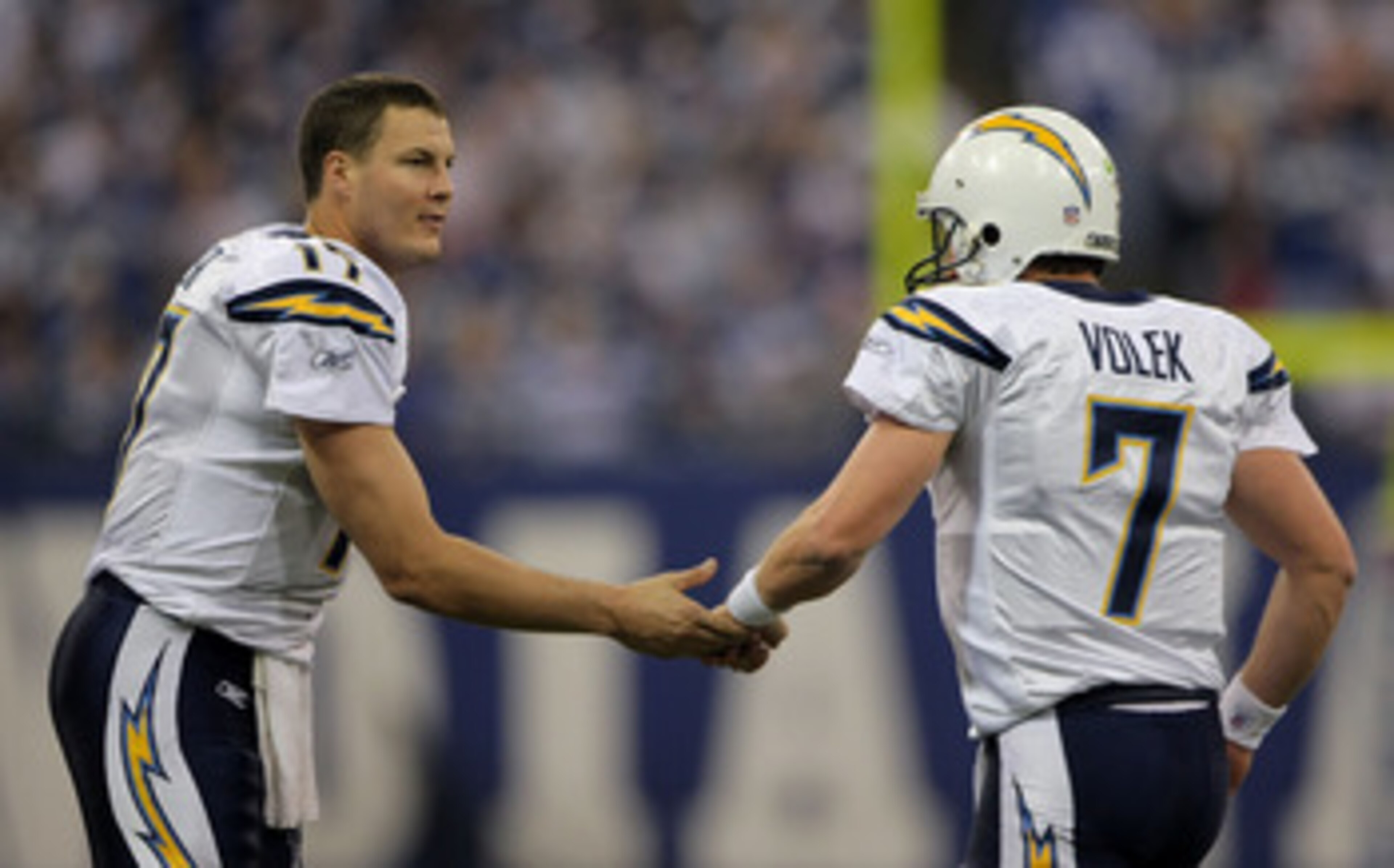 INDIANAPOLIS - JANUARY 13:  Philip Rivers #17 of the San Diego Chargers congratulates Billy Volek #7 after Volek scored touchdown on a 1-yard run in the fourth quarter against the Indianapolis Colts during their AFC Divisional Playoff game at the RCA Dome