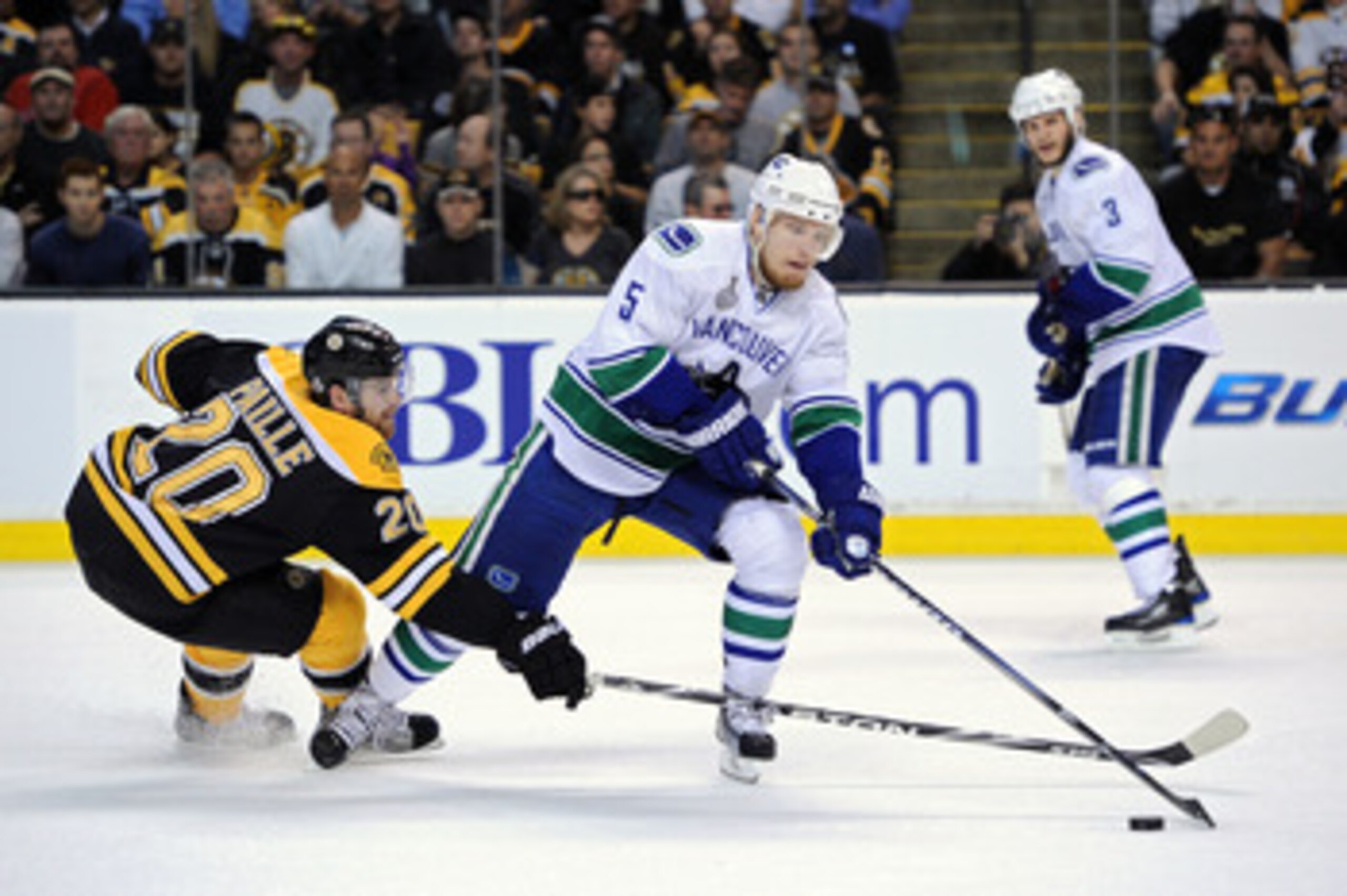 BOSTON, MA - JUNE 13:  Daniel Paille #20 of the Boston Bruins fights for the puck against Christian Ehrhoff #5 of the Vancouver Canucks during Game Six of the 2011 NHL Stanley Cup Final at TD Garden on June 13, 2011 in Boston, Massachusetts.  (Photo by Ha