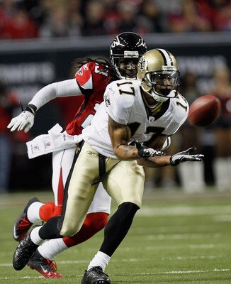 ATLANTA, GA - DECEMBER 27:  Robert Meachem #17 of the New Orleans Saints reaches for a pass as Atlanta Falcons defender Dunta Robinson #23 looks on in the first half during their game at the Georgia Dome on December 27, 2010 in Atlanta, Georgia.  (Photo b