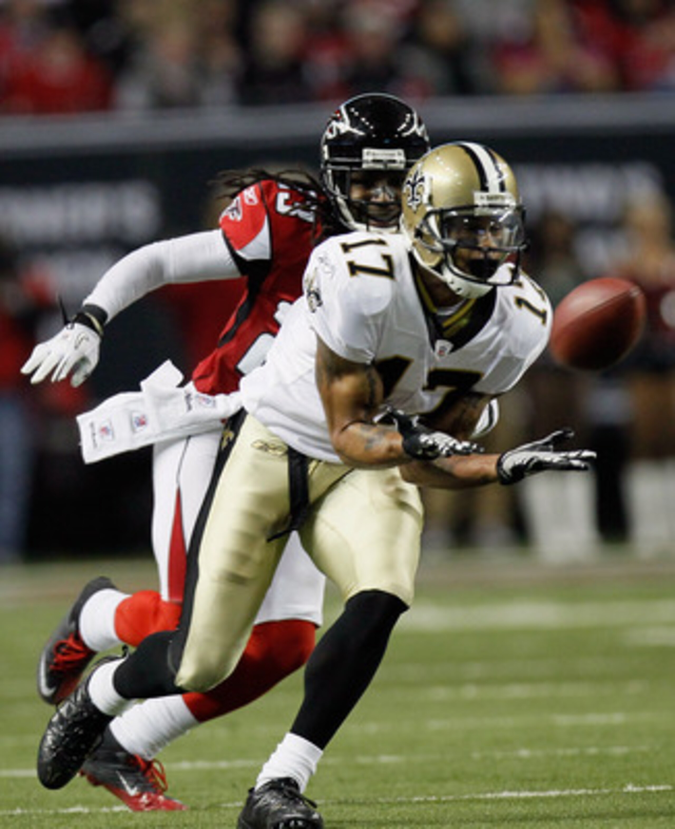 ATLANTA, GA - DECEMBER 27:  Robert Meachem #17 of the New Orleans Saints reaches for a pass as Atlanta Falcons defender Dunta Robinson #23 looks on in the first half during their game at the Georgia Dome on December 27, 2010 in Atlanta, Georgia.  (Photo b