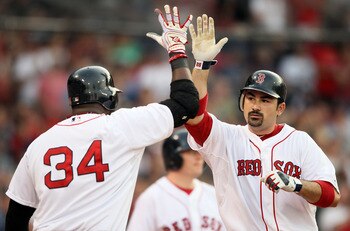 BOSTON, MA - MAY 30:  Adrian Gonzalez #28 of the Boston Red Sox is congratulated by teammate David Ortiz #34 after Gonzalez hits a a solo home run in the first inning against the Chicago White Sox on May 30, 2011 at Fenway Park in Boston, Massachusetts.