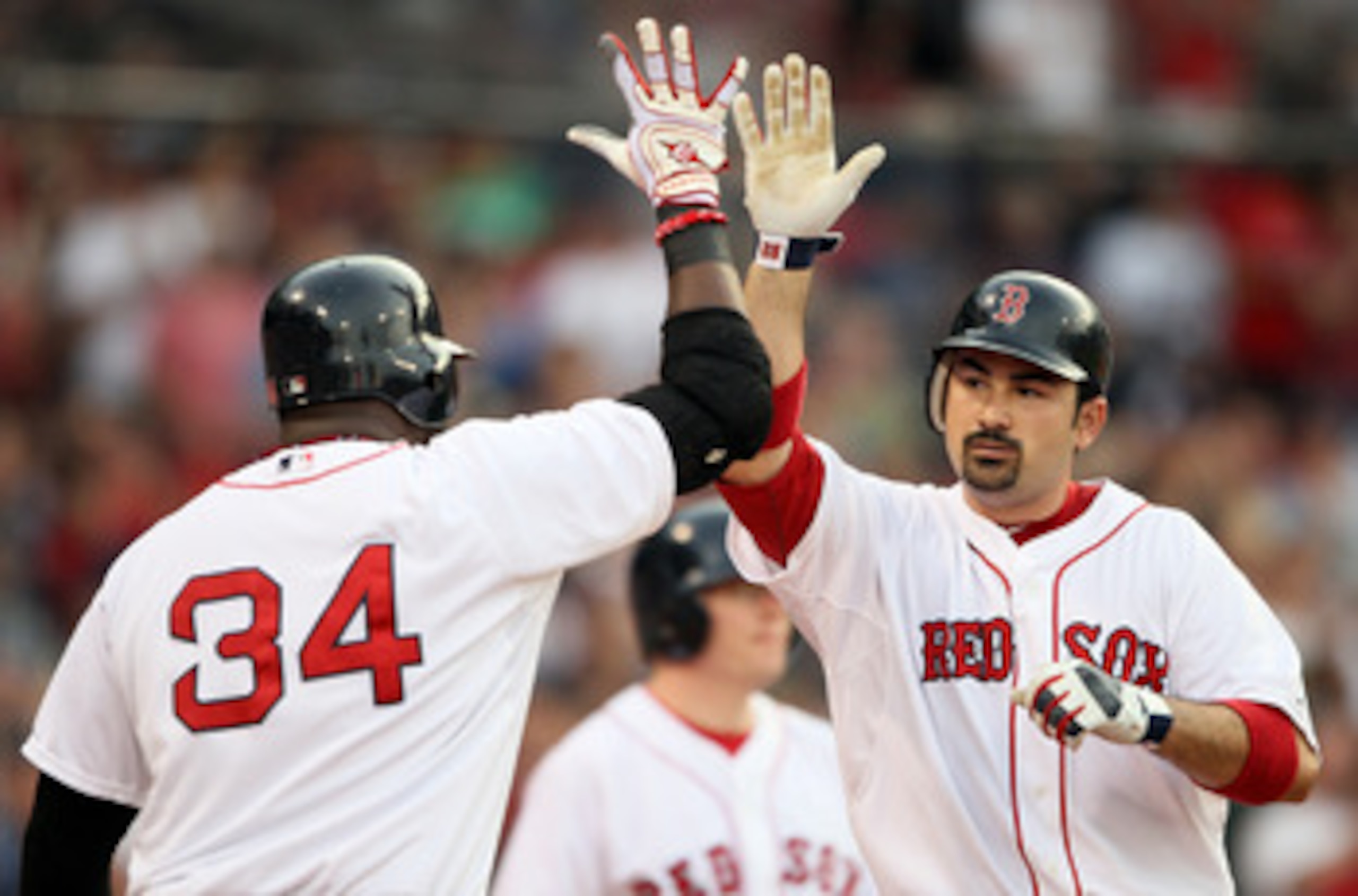 BOSTON, MA - MAY 30:  Adrian Gonzalez #28 of the Boston Red Sox is congratulated by teammate David Ortiz #34 after Gonzalez hits a a solo home run in the first inning against the Chicago White Sox on May 30, 2011 at Fenway Park in Boston, Massachusetts.