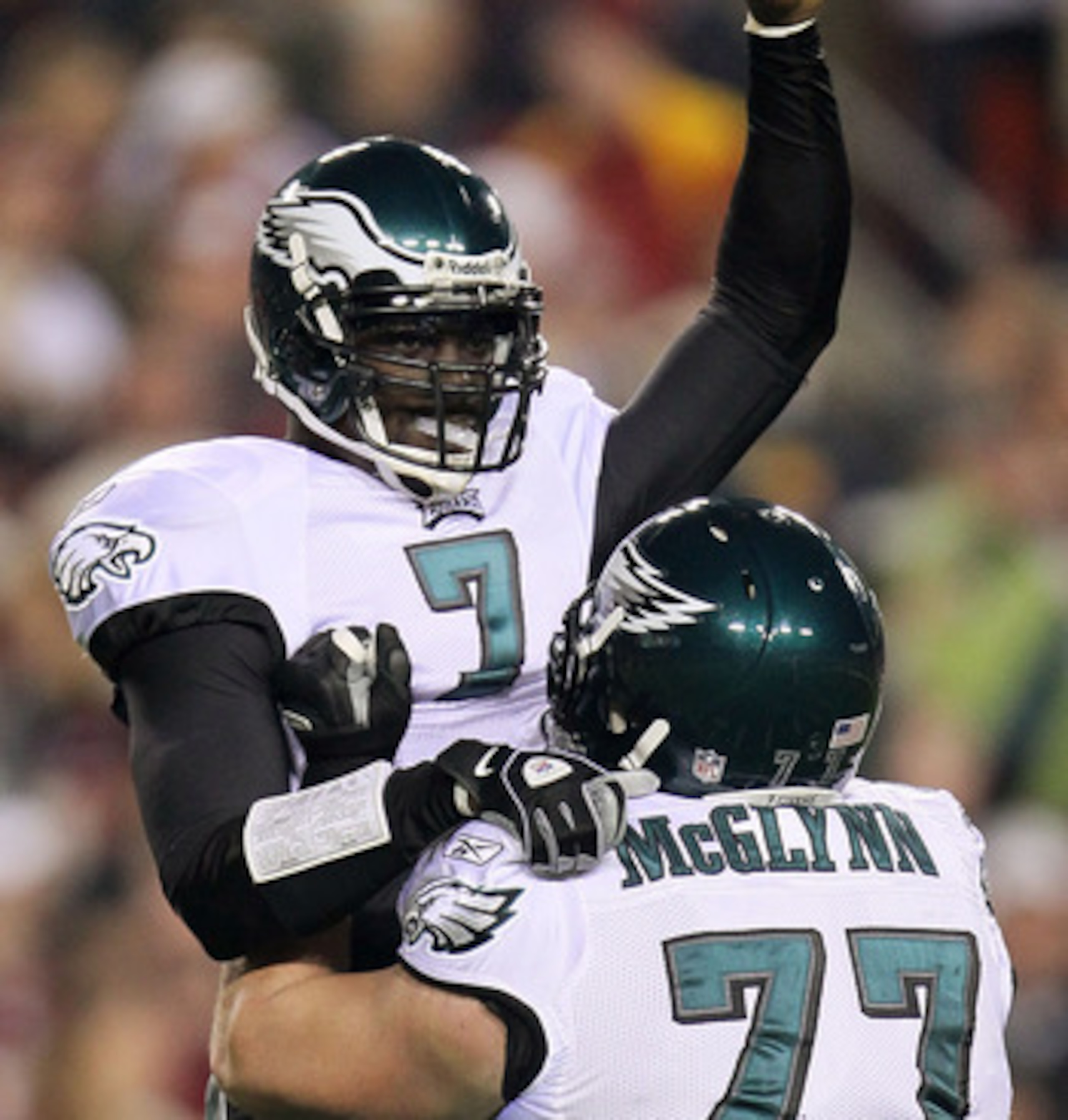 LANDOVER, MD - NOVEMBER 15:  Michael Vick #7 of the Philadelphia Eagles celebrates with team mate Mike McGlynn #77 after throwing his teams first touchdown against the Washington Redskins on November 15, 2010 at FedExField in Landover, Maryland.  (Photo b