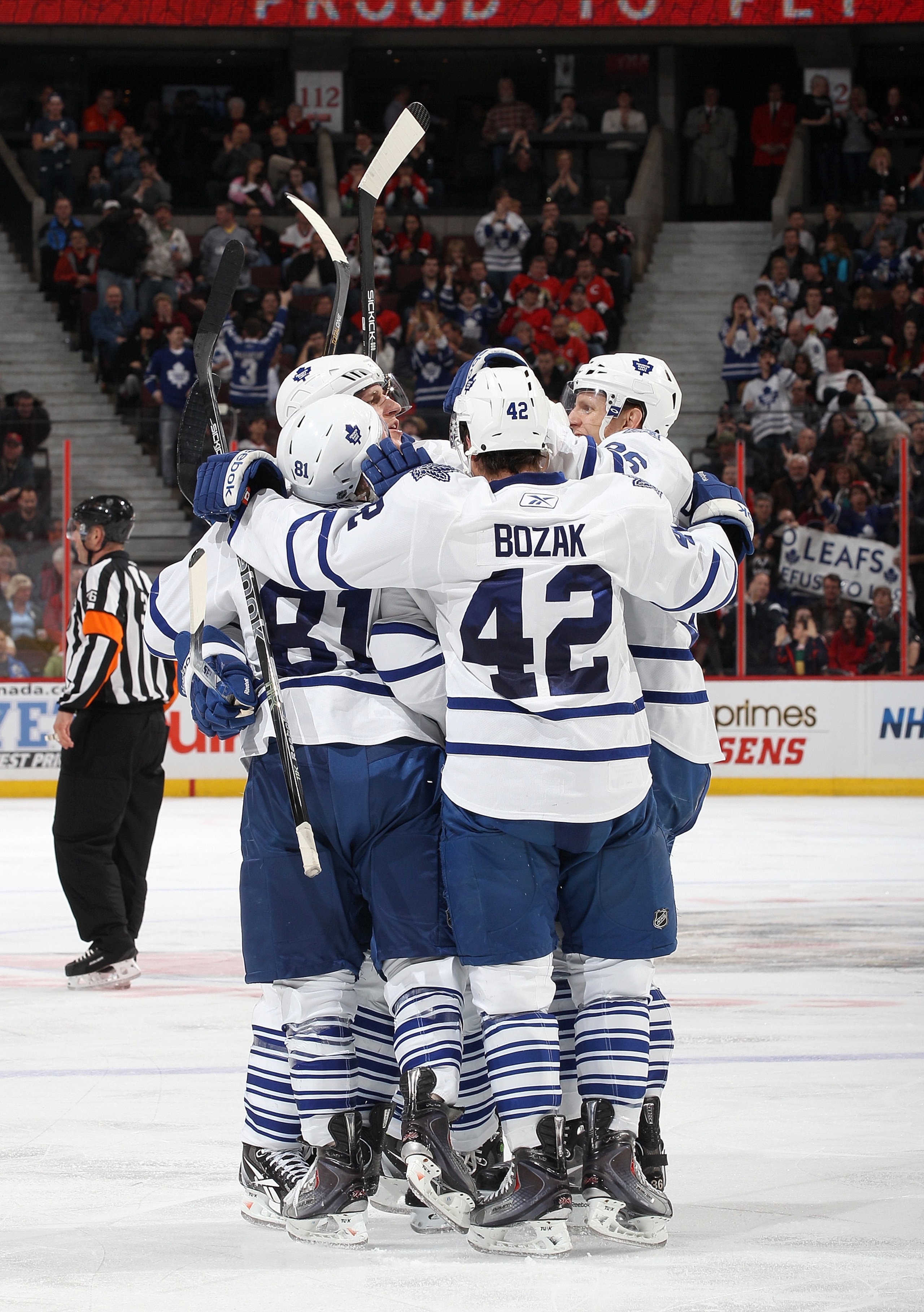OTTAWA, CANADA - APRIL 2: Tyler Bozak #42 of the Toronto Maple Leafs celebrates his third period goal with team mates Phil Kessel #81Carl Gunnarsson #36 against the Ottawa Senators at Scotiabank Place on April 2, 2011 in Ottawa, Ontario, Canada.  (Photo b