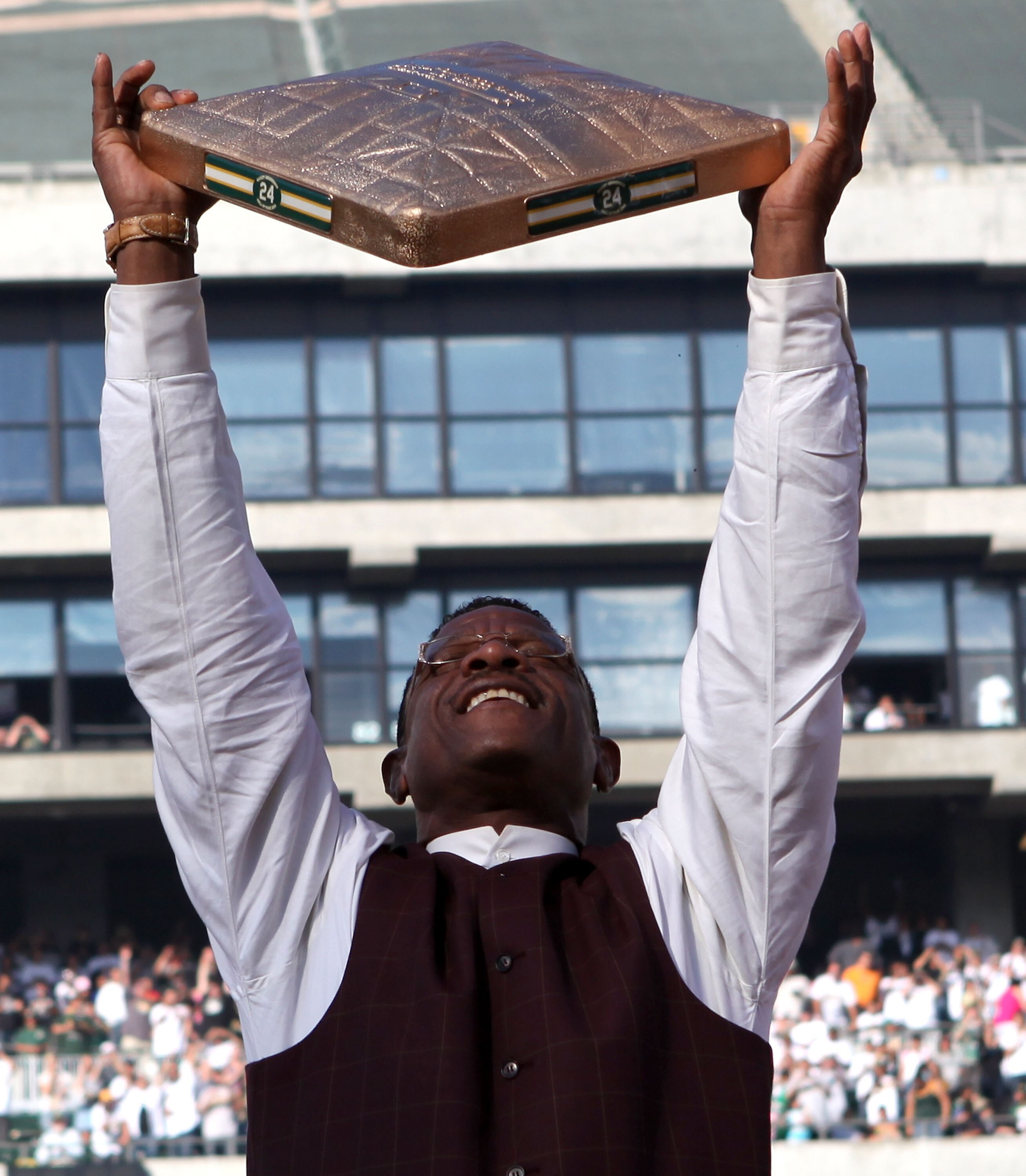 OAKLAND, CA - AUGUST 01:  Hall of Fame baseball player Rickey Henderson holds up a golden base during a ceremony to retire his number 24 by the Oakland Athletics before the start of the game against the Toronto Blue Jays August 1, 2009 at the McAfee Colis