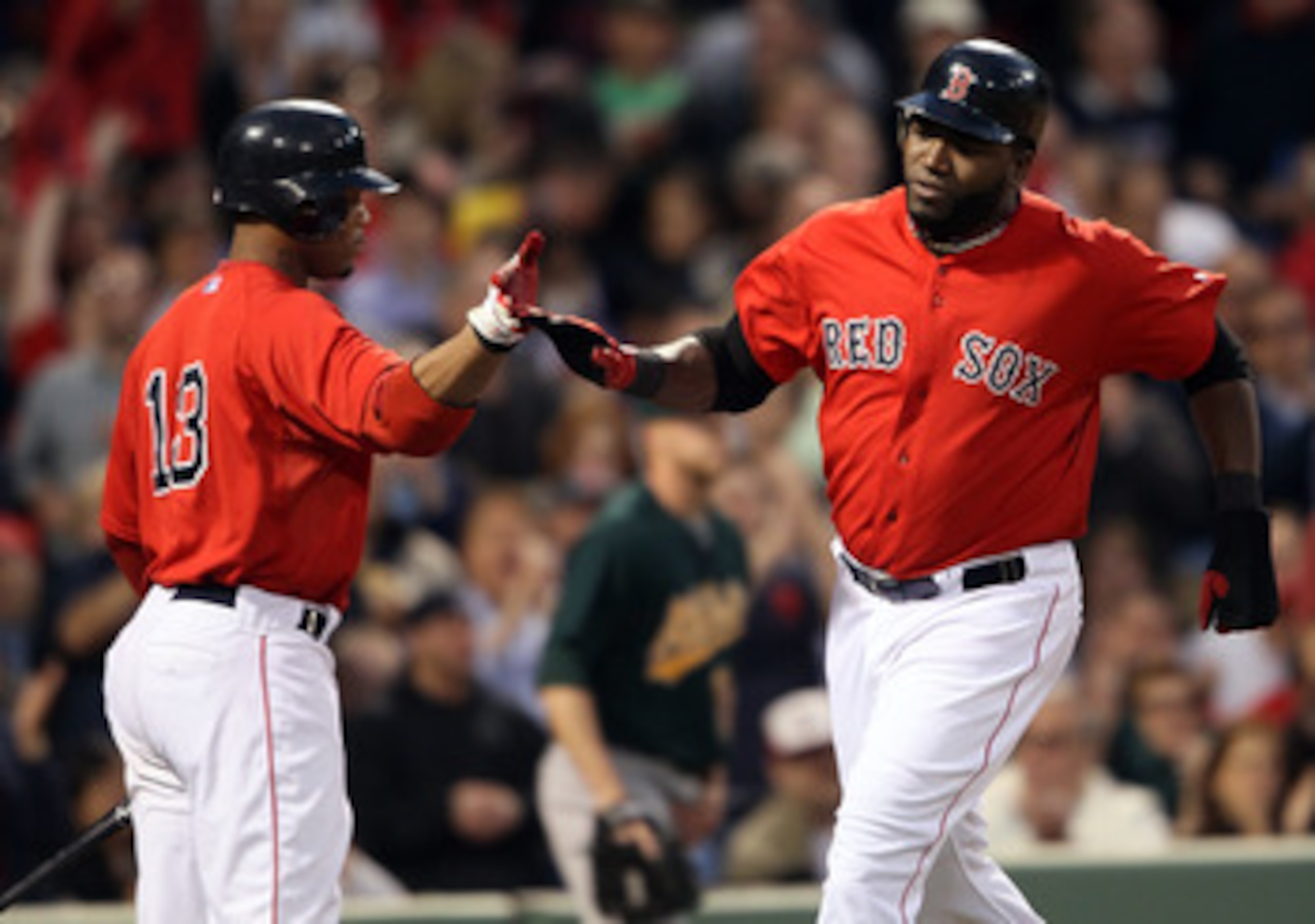 BOSTON, MA - JUNE 03:  David Ortiz #34 of the Boston Red Sox celebrates his run with teammate Carl Crawford #13 after Ortiz scored in the third inning against the Oakland Athletics on June 3, 2011 at Fenway Park in Boston, Massachusetts.  (Photo by Elsa/G