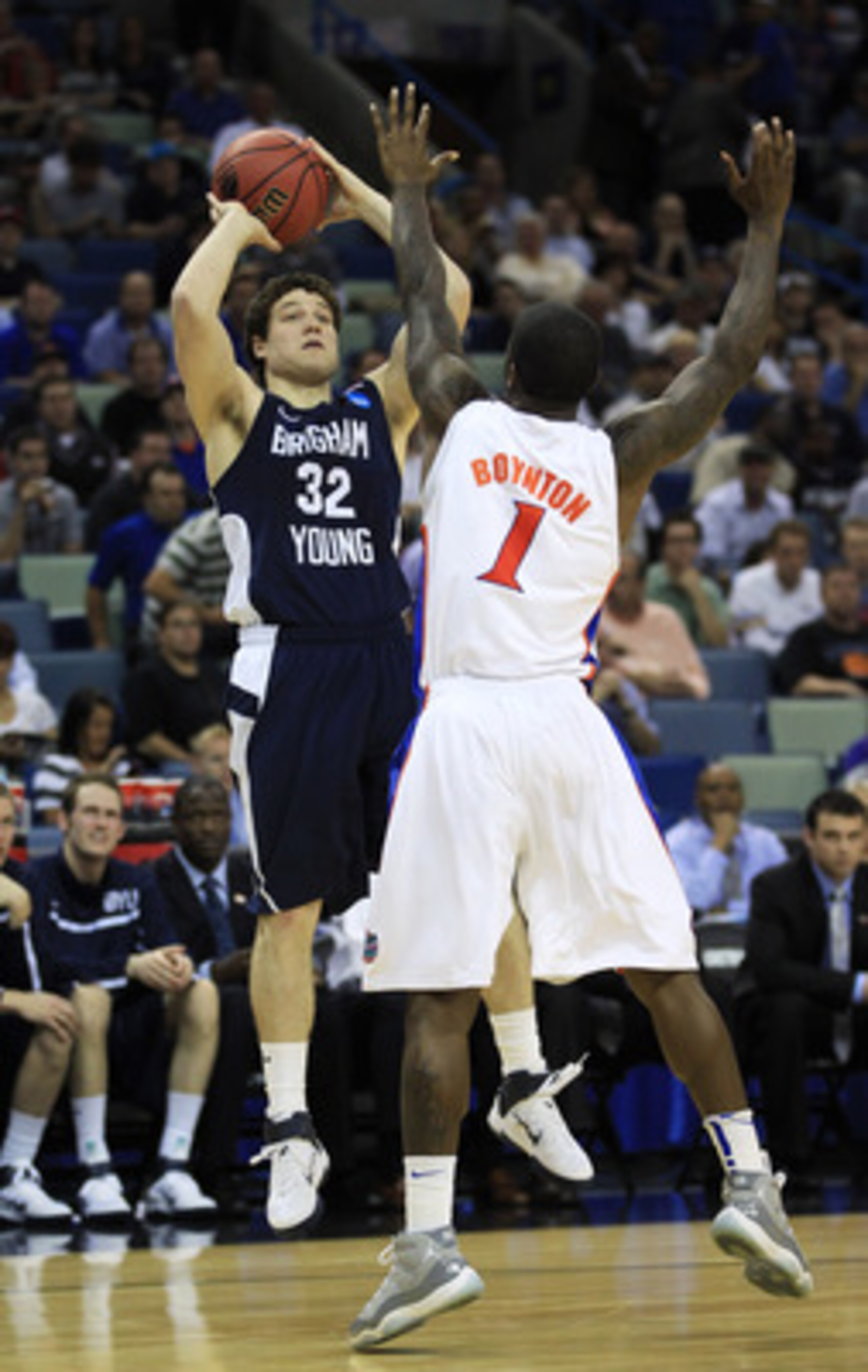 NEW ORLEANS, LA - MARCH 24:  Jimmer Fredette #32 of the Brigham Young Cougars shoots over Kenny Boynton #1 of the Florida Gators in the second half during the Southeast regional of the 2011 NCAA men's basketball tournament at New Orleans Arena on March 24