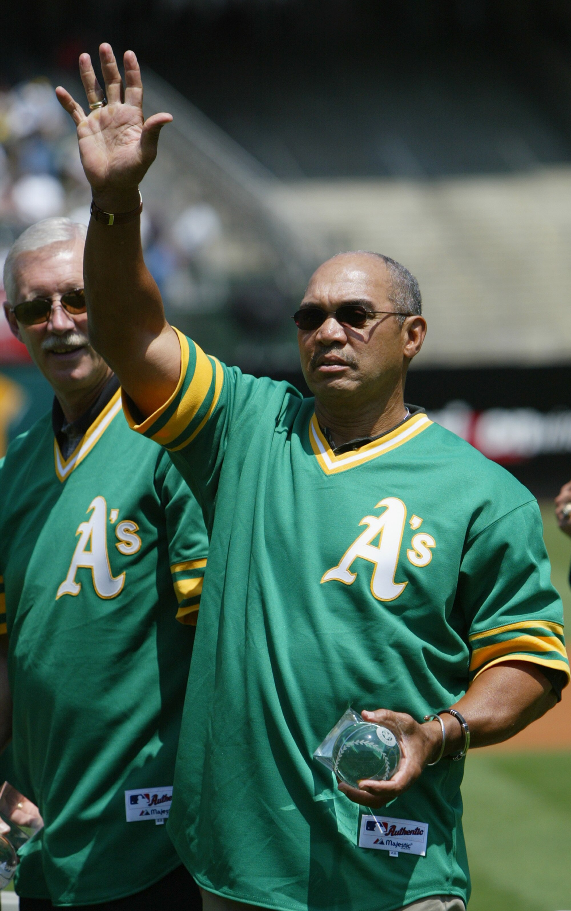OAKLAND, CA - AUGUST 2:  Baseball hall of famer Reggie Jackson of the 1973 World Champion Oakland Athletics waves to the crowd during a ceremony before the game against the New York Yankees at the Network Associates Coliseum on August 2, 2003 in Oakland,