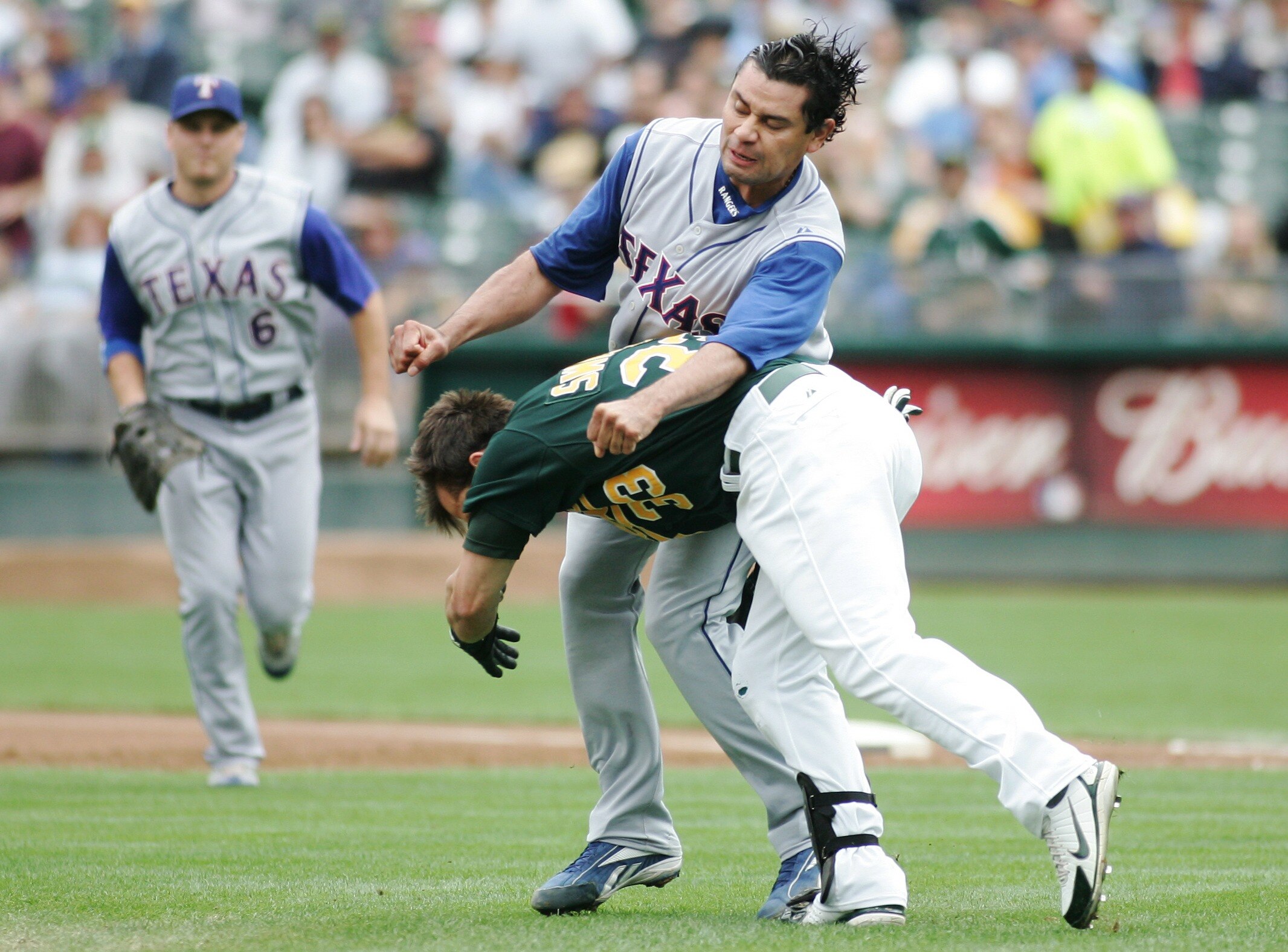 OAKLAND, CA - SEPTEMBER 16:  Nick Swisher #33 of the Oakland Athletics tackles Vicente Padilla #44 of the Texas Rangers after being hit by a pitch from Padilla in the first inning of the MLB game at the McAfee Coliseum on September 16, 2007 in Oakland, Ca
