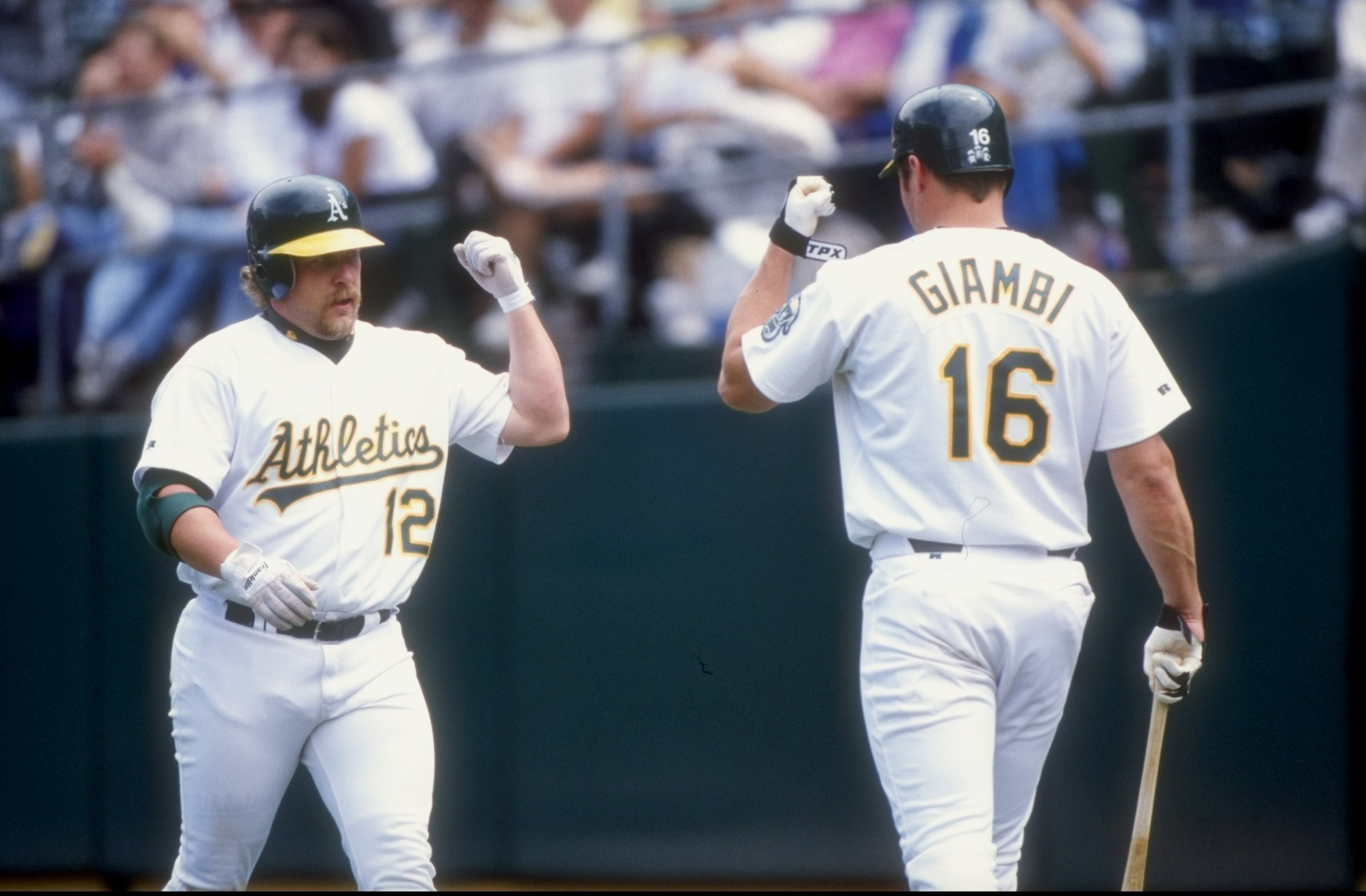 30 Jul 1998:  Outfielder Matt Stairs #12 of the Oakland Athletics greets infielder Jason Giambi #16 during a game against the Boston Red Sox at the Oakland Coliseum in Oakland, California. The Athletics defeated the Red Sox 6-5. Mandatory Credit: Otto Gre
