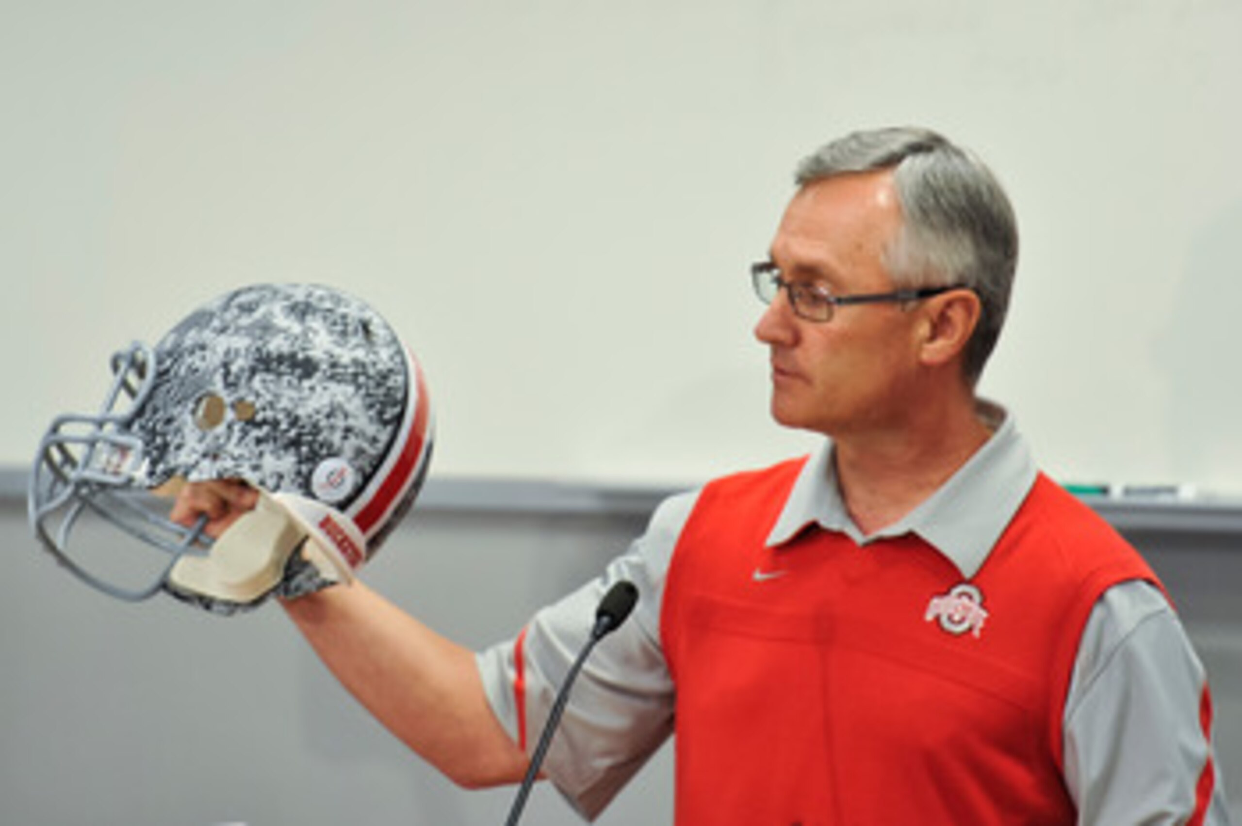 COLUMBUS, OH - MARCH 30:  Head Coach Jim Tressel shows off a football helmet with military camouflage to the media during a press conference before the start of Spring practices at the Woody Hayes Athletic Center at The Ohio State University on March 30,