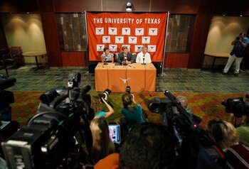 AUSTIN, TX - JUNE 15:  University of Texas at Austin President William Powers Jr., center, Women's Athletics Director Chris Plonskon, left, and Men's Athletics Director DeLoss Dodds, right, announce the athletics programs will continue competing in the Bi