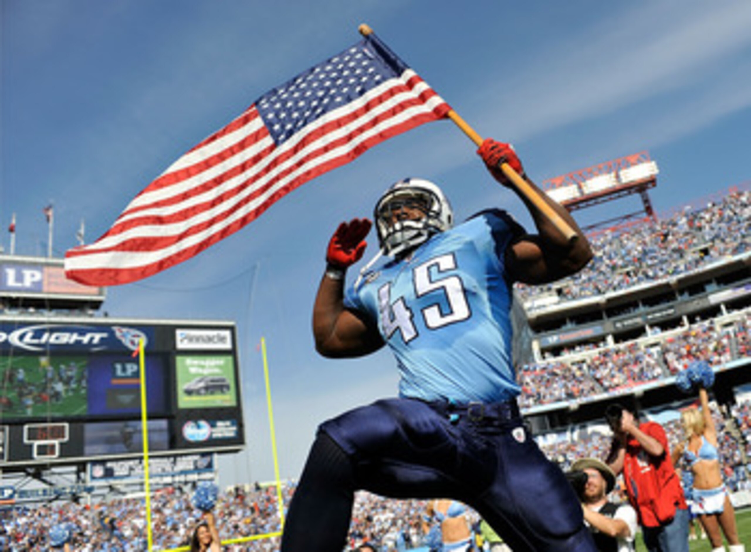 NASHVILLE, TN - NOVEMBER 21: Ahmard Hall #45 of the Tennessee Titans, an armed services veteran, brings out the American flag before a game against the Washington Redskins at LP Field on November 21, 2010 in Nashville, Tennessee. (Photo by Grant Halvers NASHVILLE, TN - NOVEMBER 21: Ahmard Hall #45 of the Tennessee Titans, an armed services veteran, brings out the American flag before a game against the Washington Redskins at LP Field on November 21, 2010 in Nashville, Tennessee. (Photo by Grant Halvers