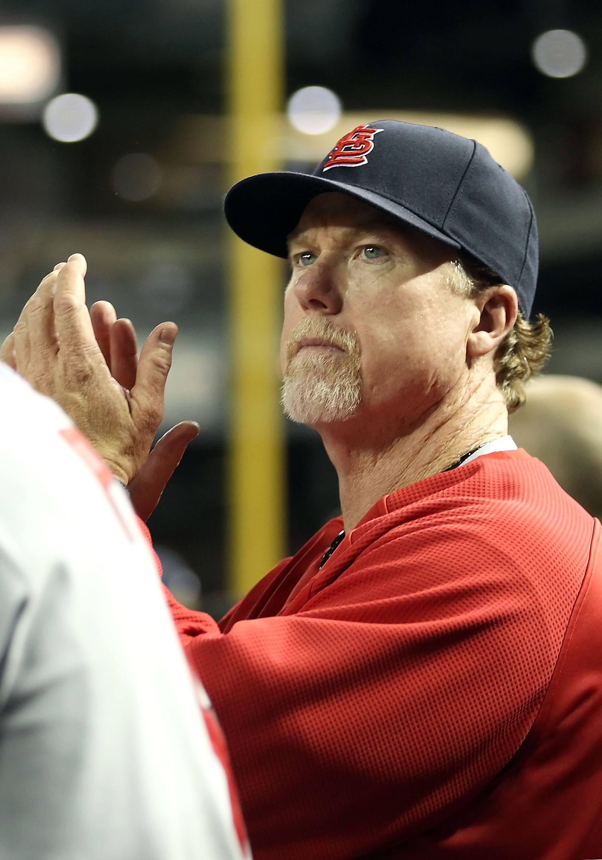 PHOENIX, AZ - APRIL 12:  Batting coach Mark McGwire of the St. Louis Cardinals watches from the dugout during the Major League Baseball game against the Arizona Diamondbacks at Chase Field on April 12, 2011 in Phoenix, Arizona.  The Diamondbacks defeated