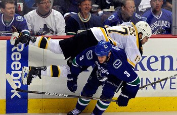 VANCOUVER, BC - JUNE 10:  Milan Lucic #17 of the Boston Bruins gets checked by Kevin Bieksa #3 of the Vancouver Canucks during Game Five of the 2011 NHL Stanley Cup Final at Rogers Arena on June 10, 2011 in Vancouver, British Columbia, Canada.  (Photo by