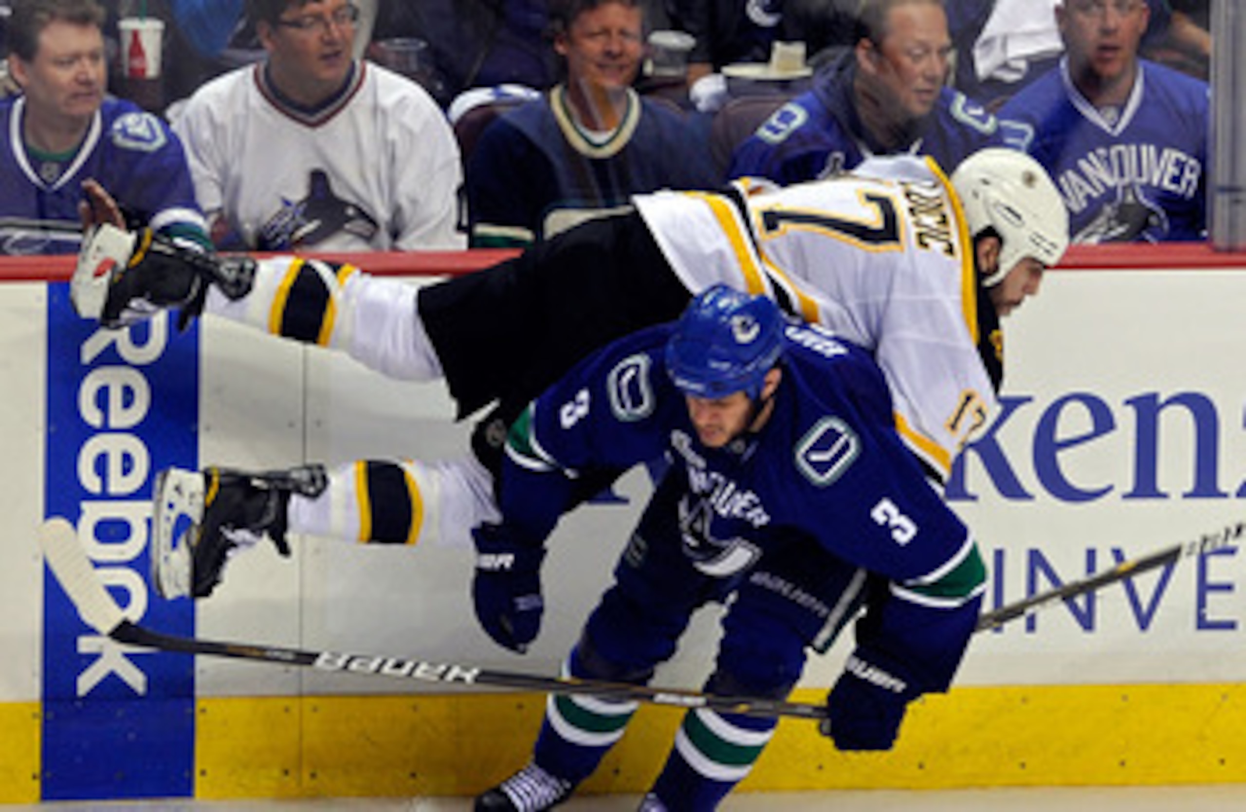 VANCOUVER, BC - JUNE 10:  Milan Lucic #17 of the Boston Bruins gets checked by Kevin Bieksa #3 of the Vancouver Canucks during Game Five of the 2011 NHL Stanley Cup Final at Rogers Arena on June 10, 2011 in Vancouver, British Columbia, Canada.  (Photo by