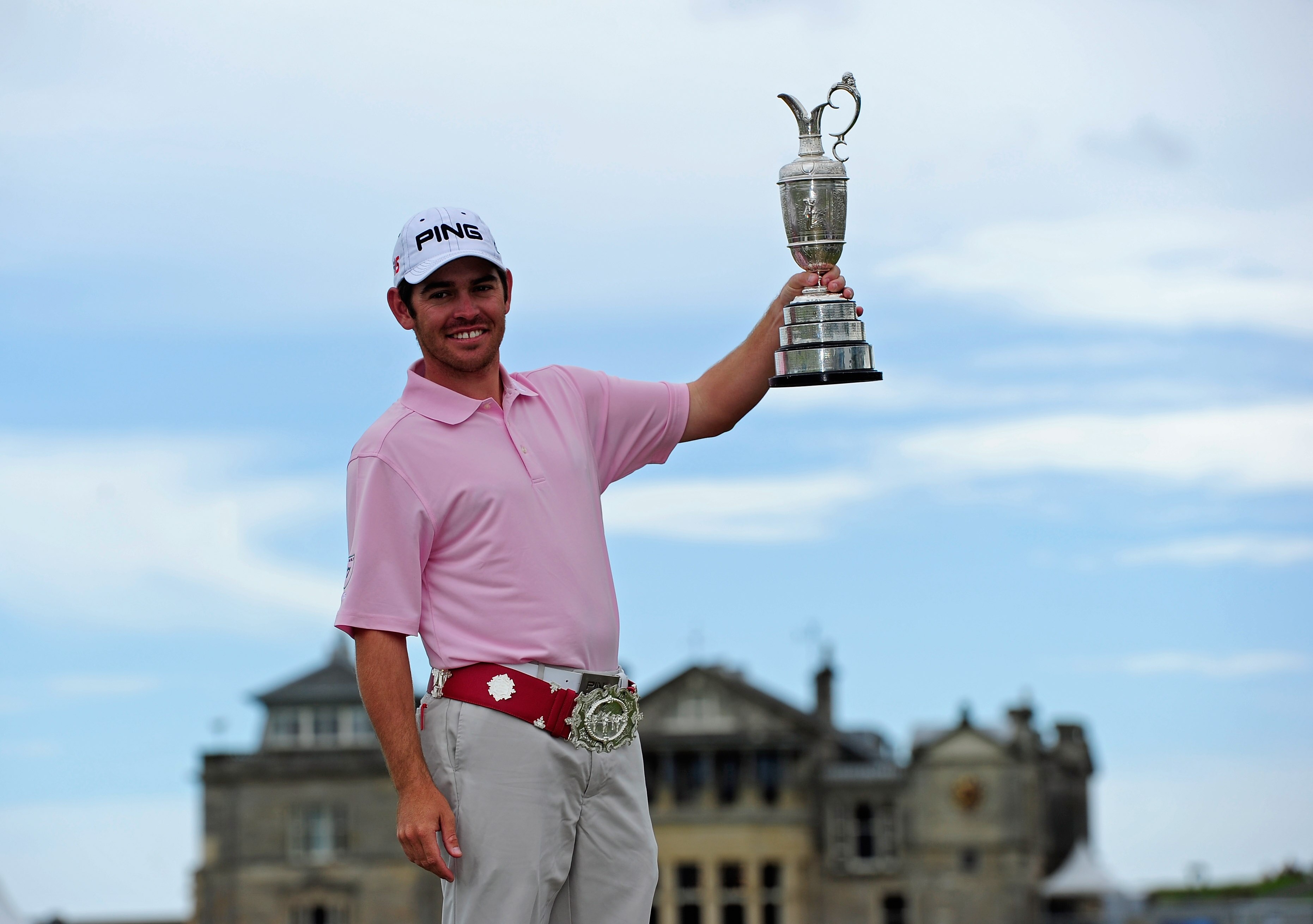 ST ANDREWS, SCOTLAND - JULY 19:  2010 Open Champion Louis Oosthuizen of South Africa poses with the Claret Jug on the Swilken bridge on July 19, 2010 in St Andrews, Scotland.  (Photo by Stuart Franklin/Getty Images)