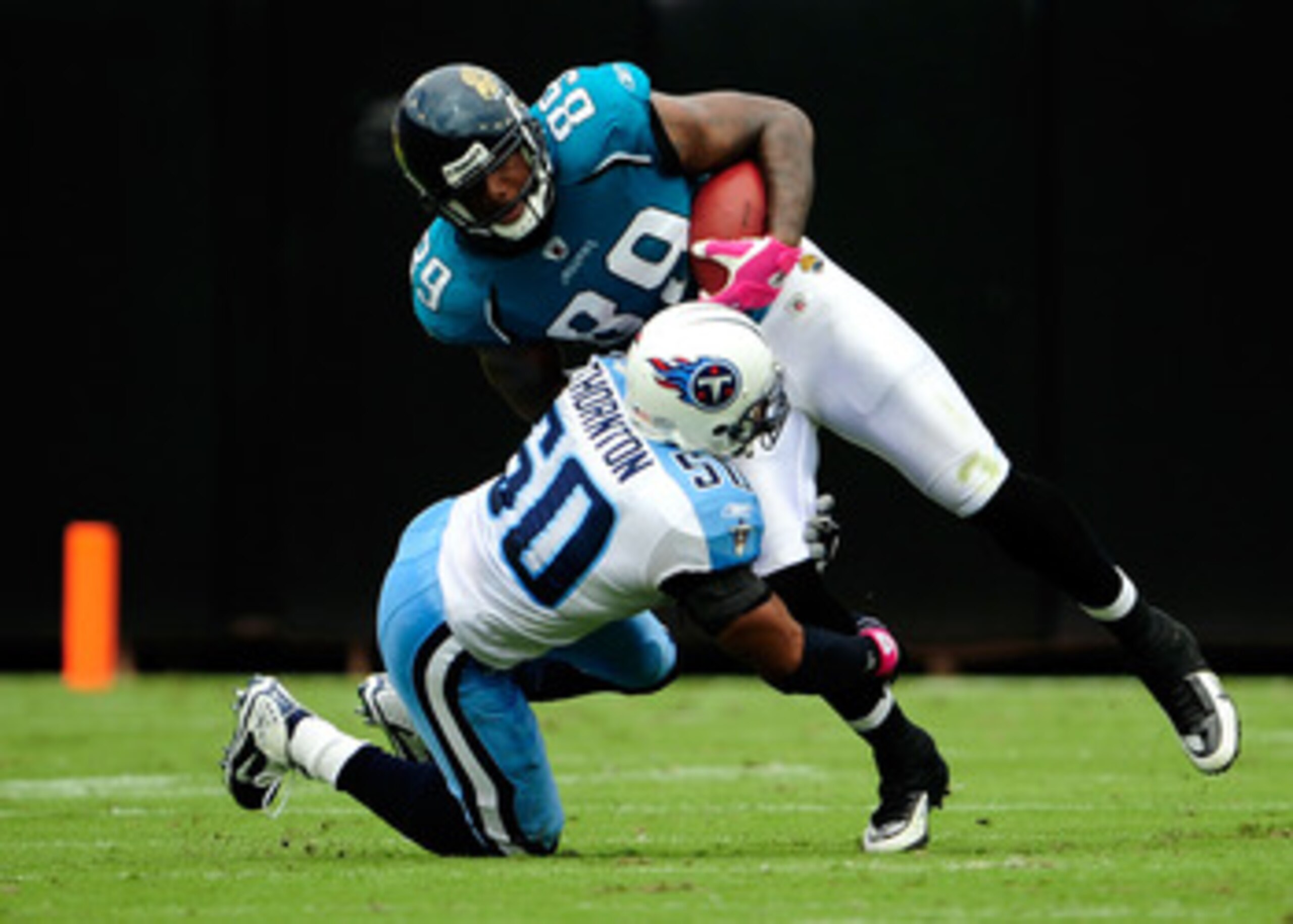 JACKSONVILLE, FL - OCTOBER 04: Marcedes Lewis #89 of the Jacksonville Jaguars is tackled by David Thornton #50 of the Tennessee Titans during the game at Jacksonville Municipal Stadium on October 4, 2009 in Jacksonville, Florida. (Photo by Sam Greenwood JACKSONVILLE, FL - OCTOBER 04: Marcedes Lewis #89 of the Jacksonville Jaguars is tackled by David Thornton #50 of the Tennessee Titans during the game at Jacksonville Municipal Stadium on October 4, 2009 in Jacksonville, Florida. (Photo by Sam Greenwood