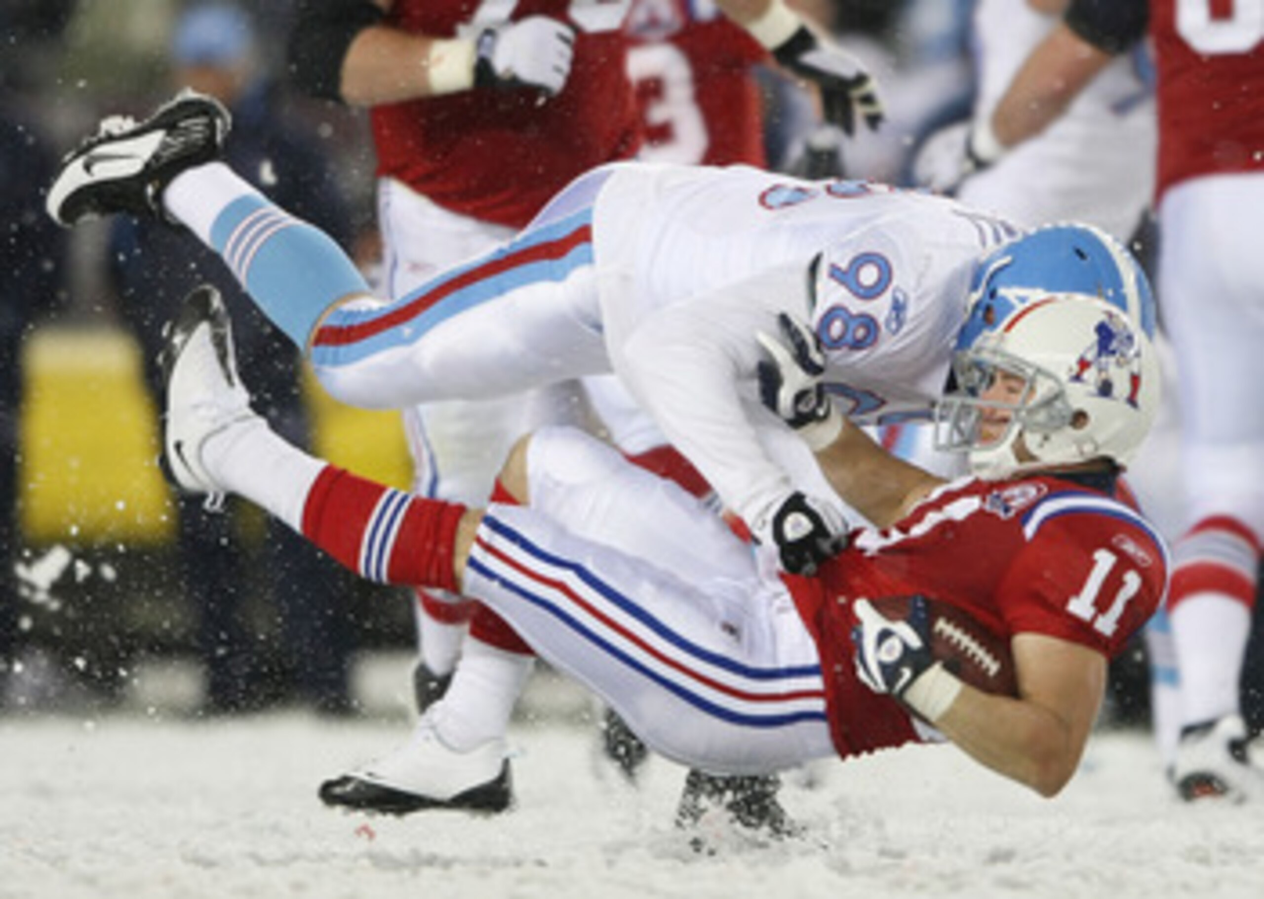 FOXBORO, MA - OCTOBER 18: Julian Edelman #11 of the New England Patriots is tackled by Dave Ball #98 of the Tennessee Titans on October 18, 2009 at Gillette Stadium in Foxboro, Massachusetts.The Patriots defeated the Titans 59-0. (Photo by Elsa/Getty Im FOXBORO, MA - OCTOBER 18: Julian Edelman #11 of the New England Patriots is tackled by Dave Ball #98 of the Tennessee Titans on October 18, 2009 at Gillette Stadium in Foxboro, Massachusetts.The Patriots defeated the Titans 59-0. (Photo by Elsa/Getty Im