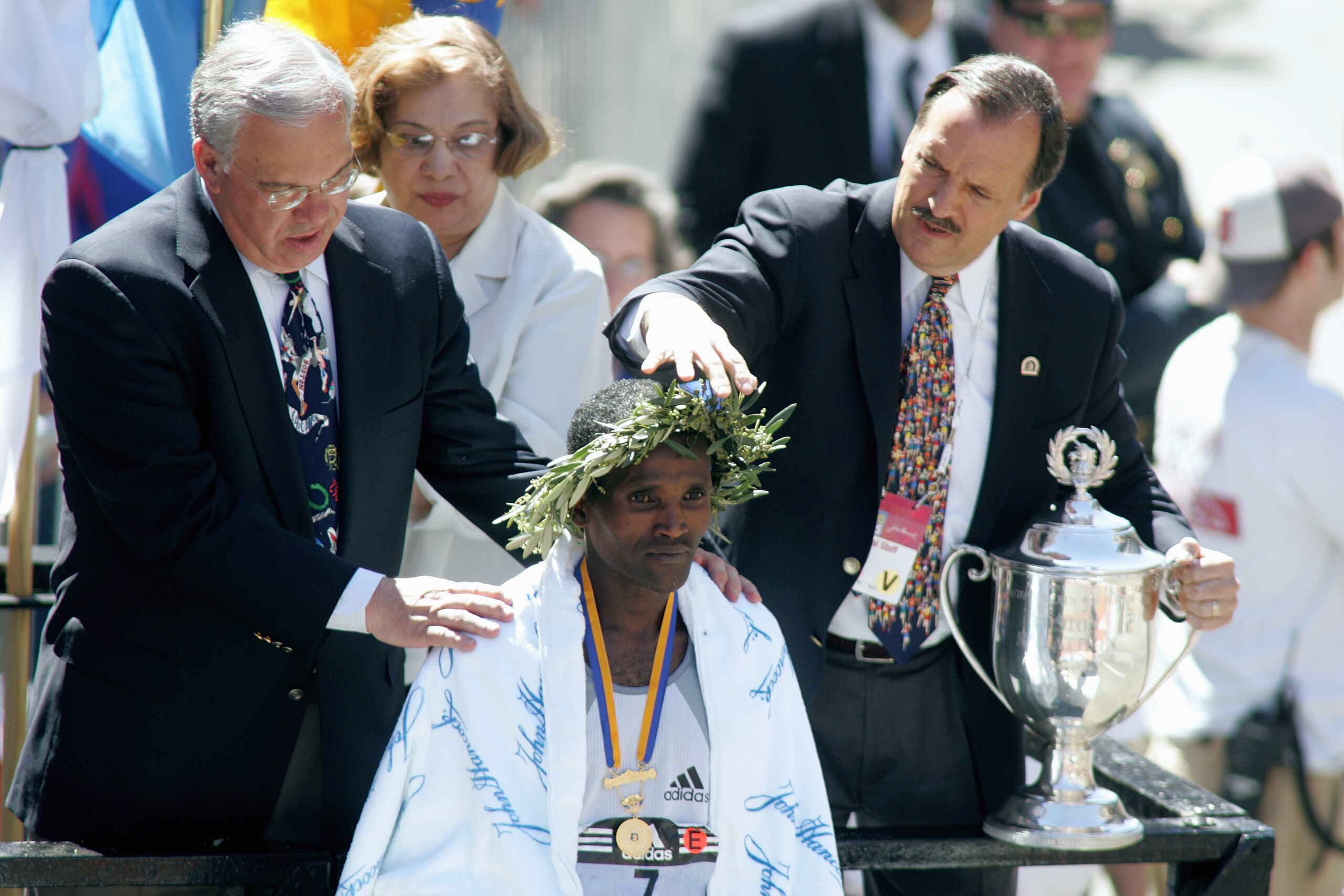 BOSTON, MA - APRIL 18: Hailu Negussie of Ethiopia is crowned with a laurel wreath after winning the men's division of the 109th Boston Marathon with a time of 2:11:45 on April 18, 2004 in Boston, Massachusetts. (Photo by Jim McIsaac/Getty Images)