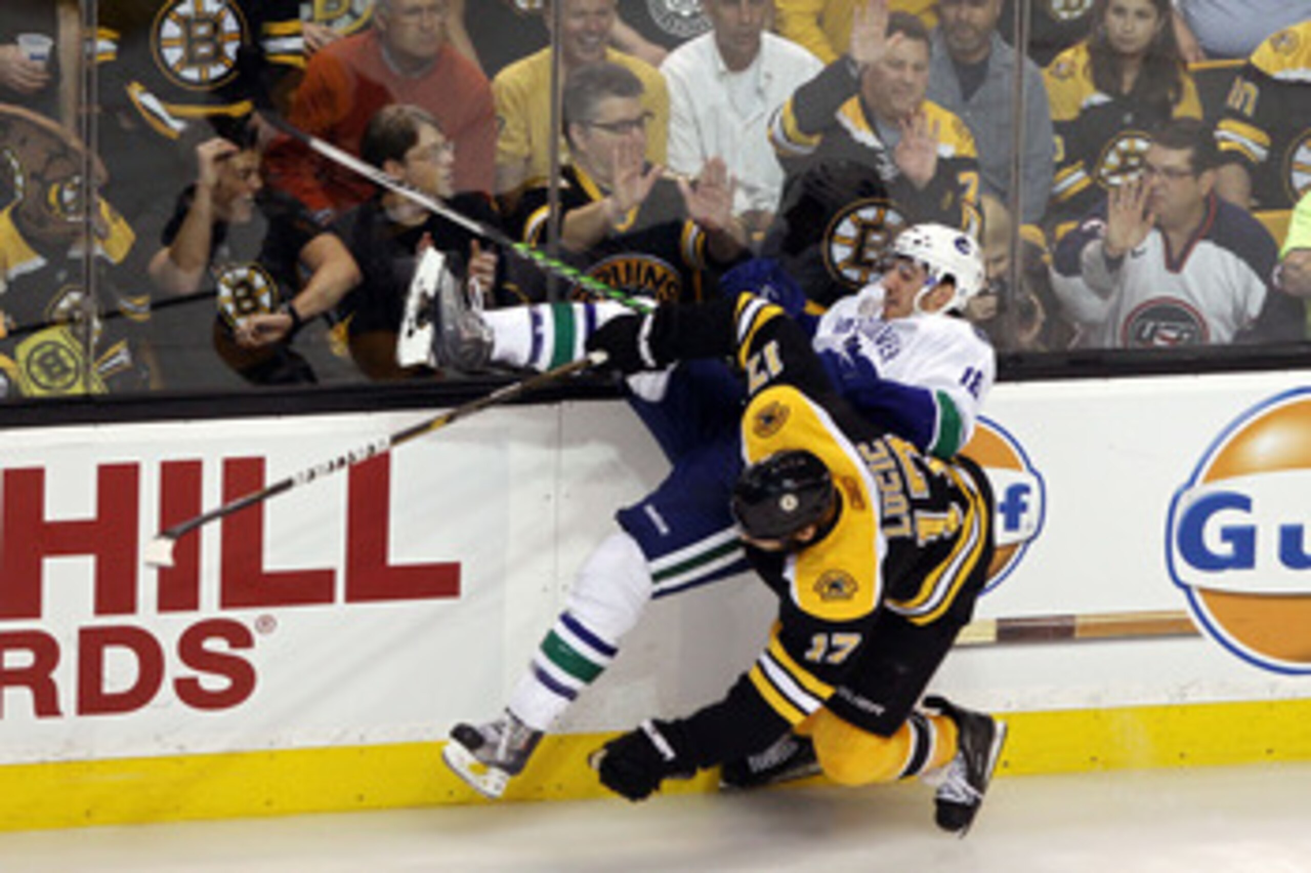 BOSTON, MA - JUNE 13:  Chris Tanev #18 of the Vancouver Canucks collides with Milan Lucic #17 of the Boston Bruins during Game Six of the 2011 NHL Stanley Cup Final at TD Garden on June 13, 2011 in Boston, Massachusetts.  (Photo by Bruce Bennett/Getty Ima