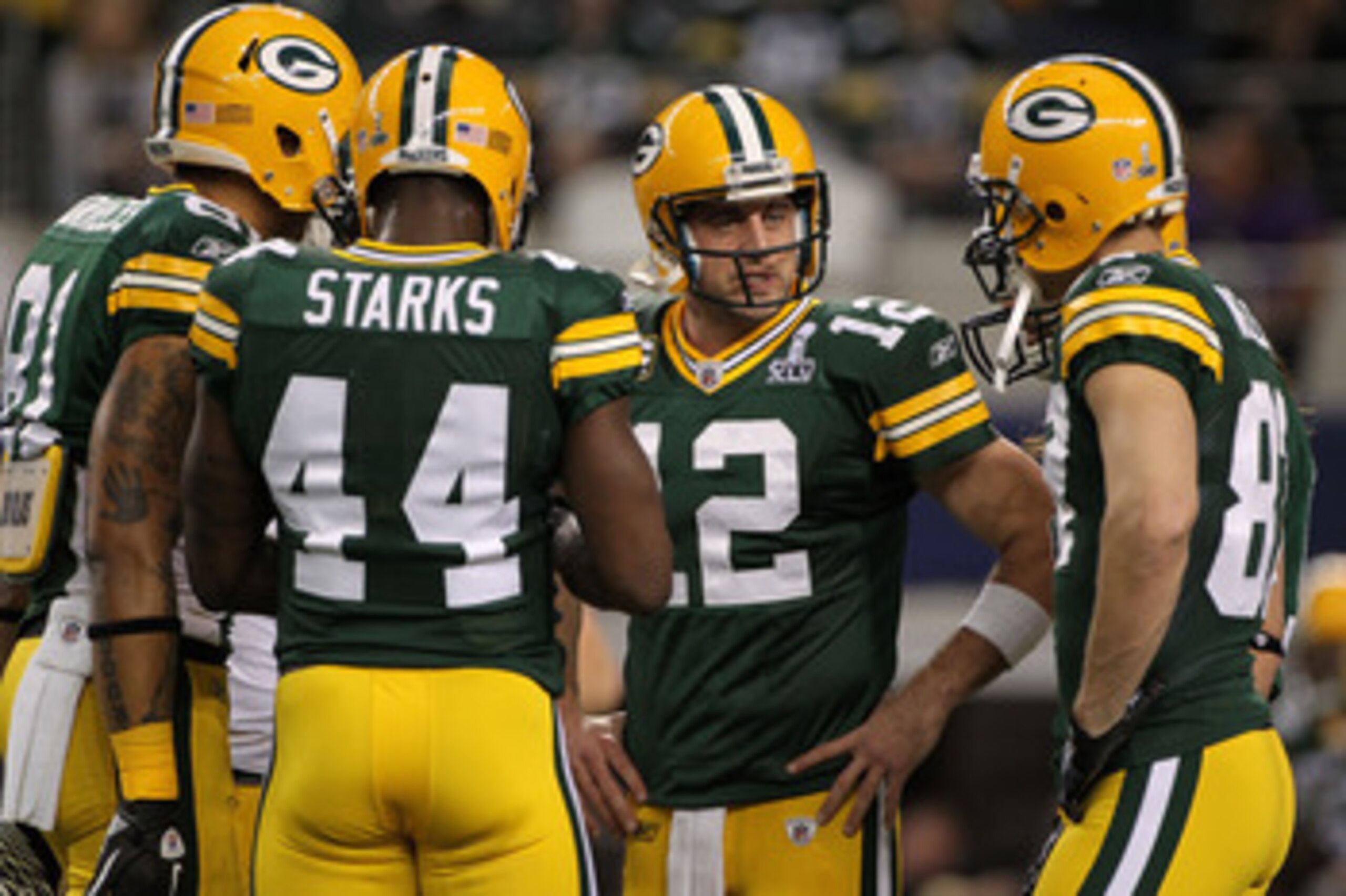 ARLINGTON, TX - FEBRUARY 06:  Aaron Rodgers #12 of the Green Bay Packers talks to teammates prior to their game against the Pittsburgh Steelers during Super Bowl XLV at Cowboys Stadium on February 6, 2011 in Arlington, Texas.  (Photo by Doug Pensinger/Get