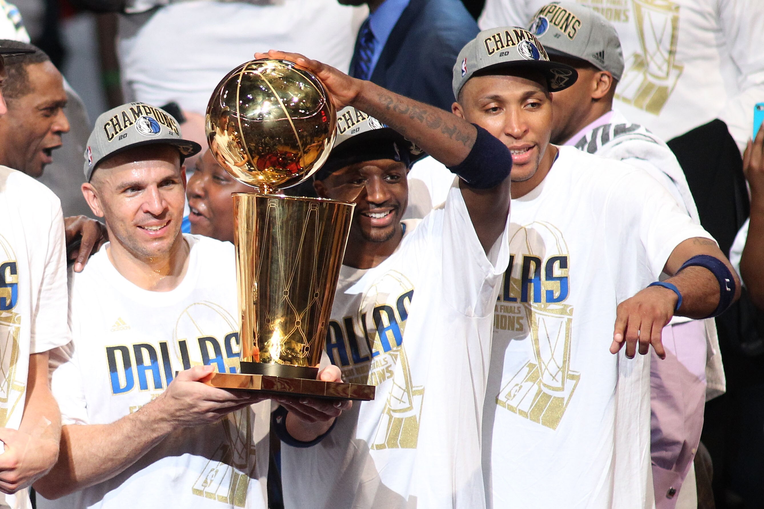 MIAMI, FL - JUNE 12:  Jason Kidd #2, Jason Terry #31 and Shawn Marion #0 of the Dallas Mavericks celebrate with the Larry O'Brien trophy after they won 105-95 against the Miami Heat in Game Six of the 2011 NBA Finals at American Airlines Arena on June 12,
