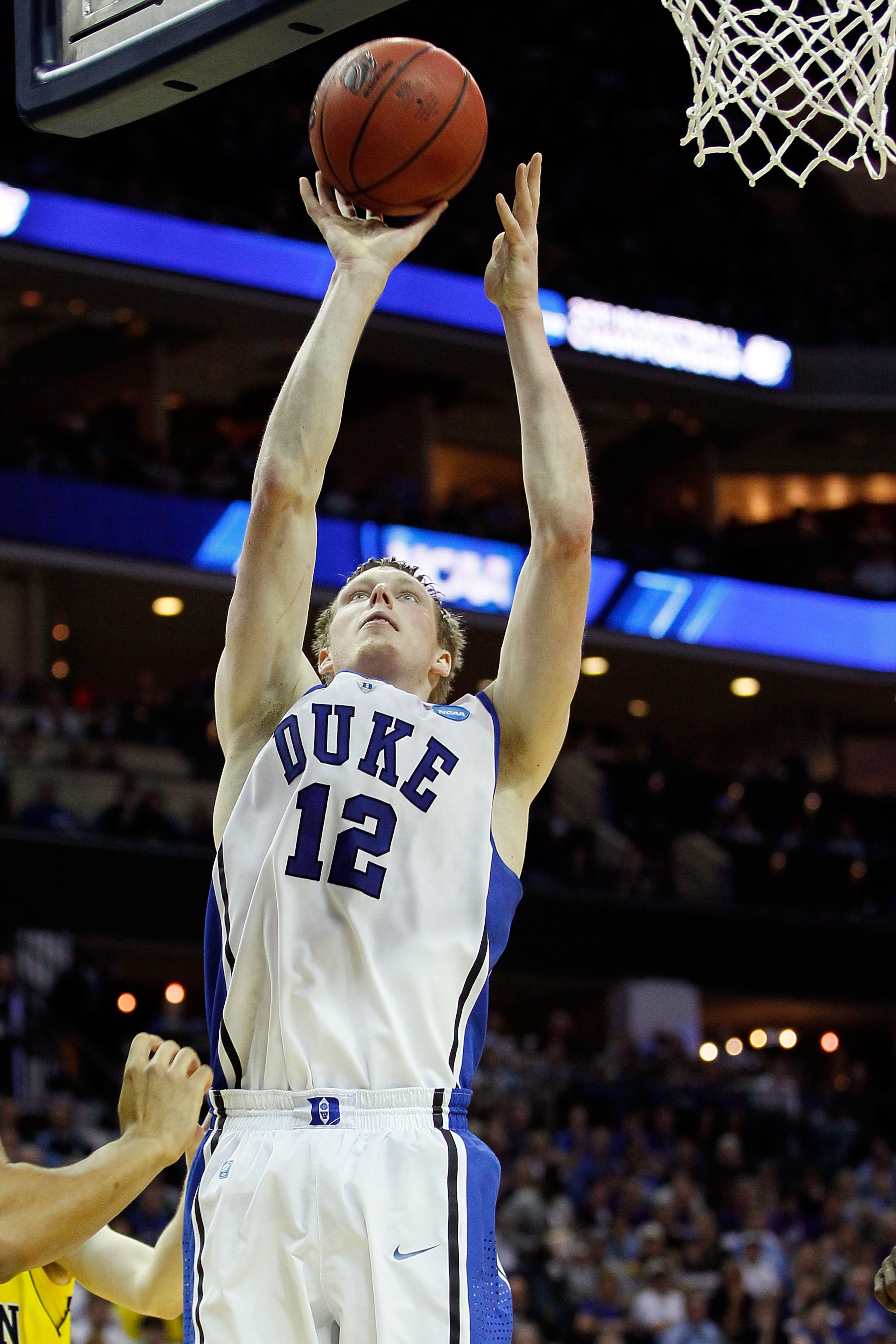 CHARLOTTE, NC - MARCH 20:  Kyle Singler #12 of the Duke Blue Devils lays the ball up while taking on the Michigan Wolverines during the third round of the 2011 NCAA men's basketball tournament at Time Warner Cable Arena on March 20, 2011 in Charlotte, Nor