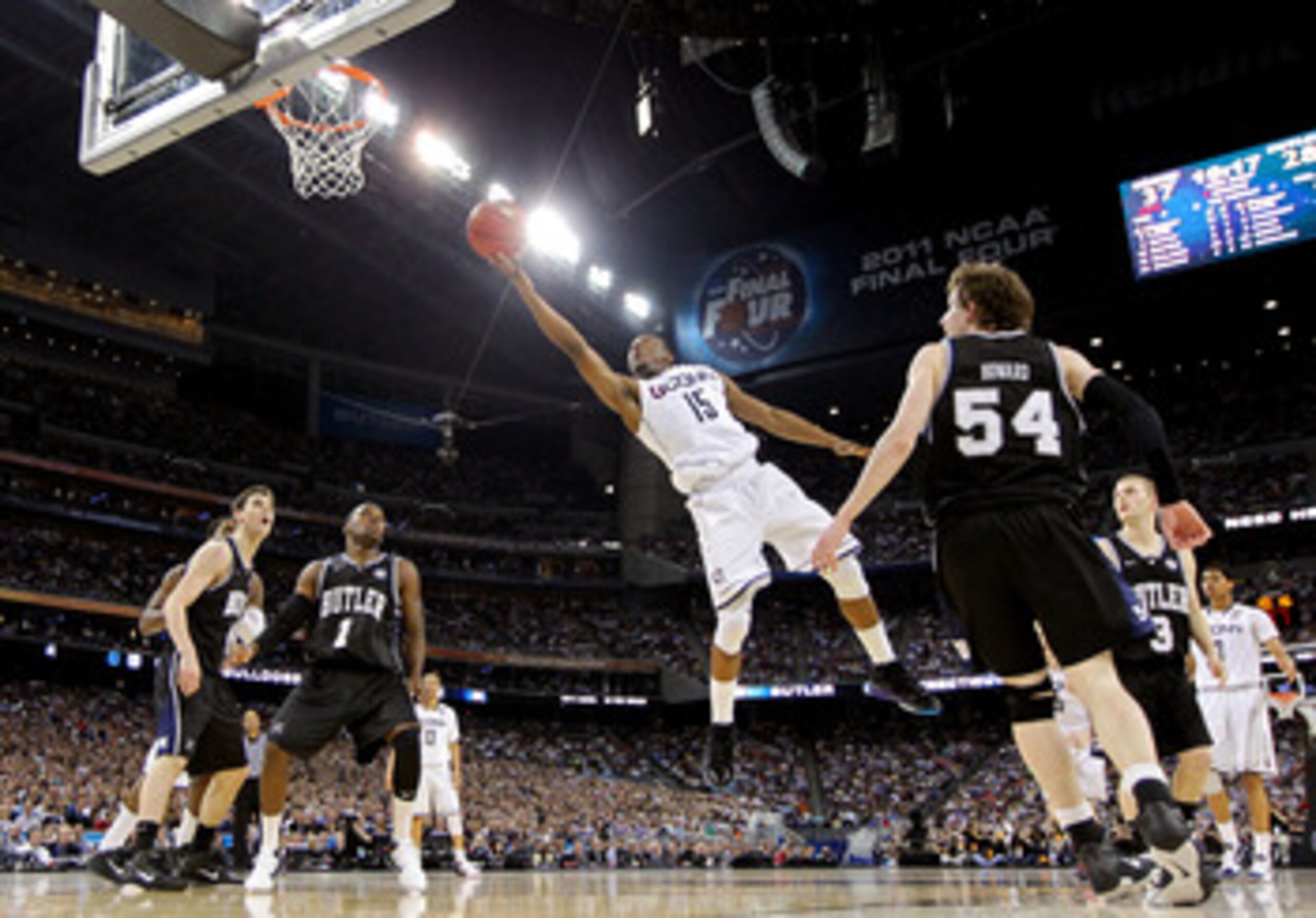 HOUSTON, TX - APRIL 04:  Kemba Walker #15 of the Connecticut Huskies goes to the basket against Matt Howard #54 and Shelvin Mack #1 of the Butler Bulldogs during the National Championship Game of the 2011 NCAA Division I Men's Basketball Tournament at Rel