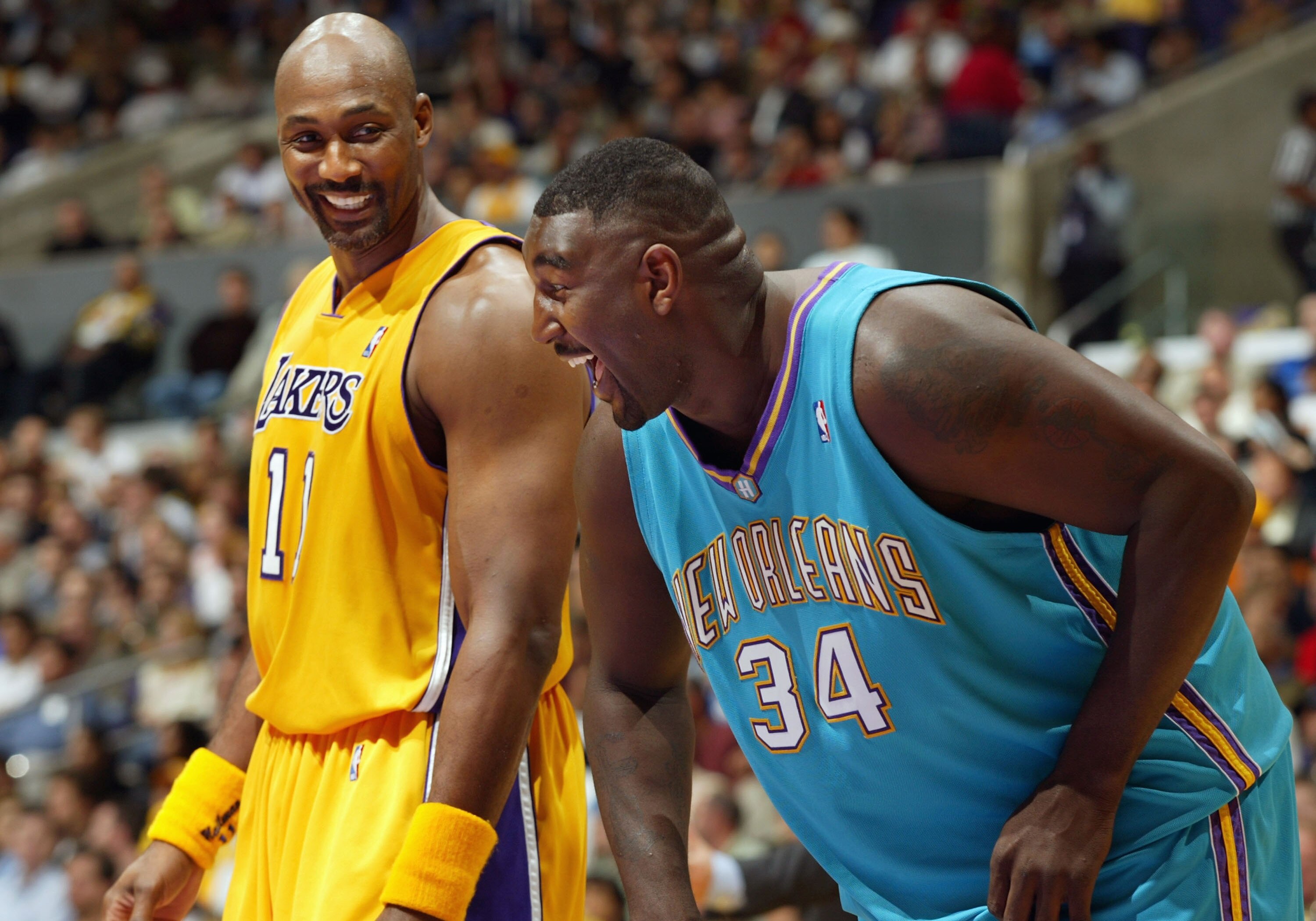 LOS ANGELES - MARCH 30:  Karl Malone #11 of the Los Angeles Lakers shares a laugh with Robert Traylor #34 of the New Orleans Hornets during the game at Staples Center on March 30, 2004 in Los Angeles, California.  NOTE TO USER: User expressly acknowledges