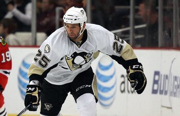 CHICAGO - OCTOBER 01: Max Talbot #25 of the Pittsburgh Penguins skates past Jonathan Toews #19 of the Chicago Blackhawks during a pre-season game at the United Center on October 1, 2010 in Chicago, Illinois. The Blackhawks defeated the Penguins 5-2.  (Pho