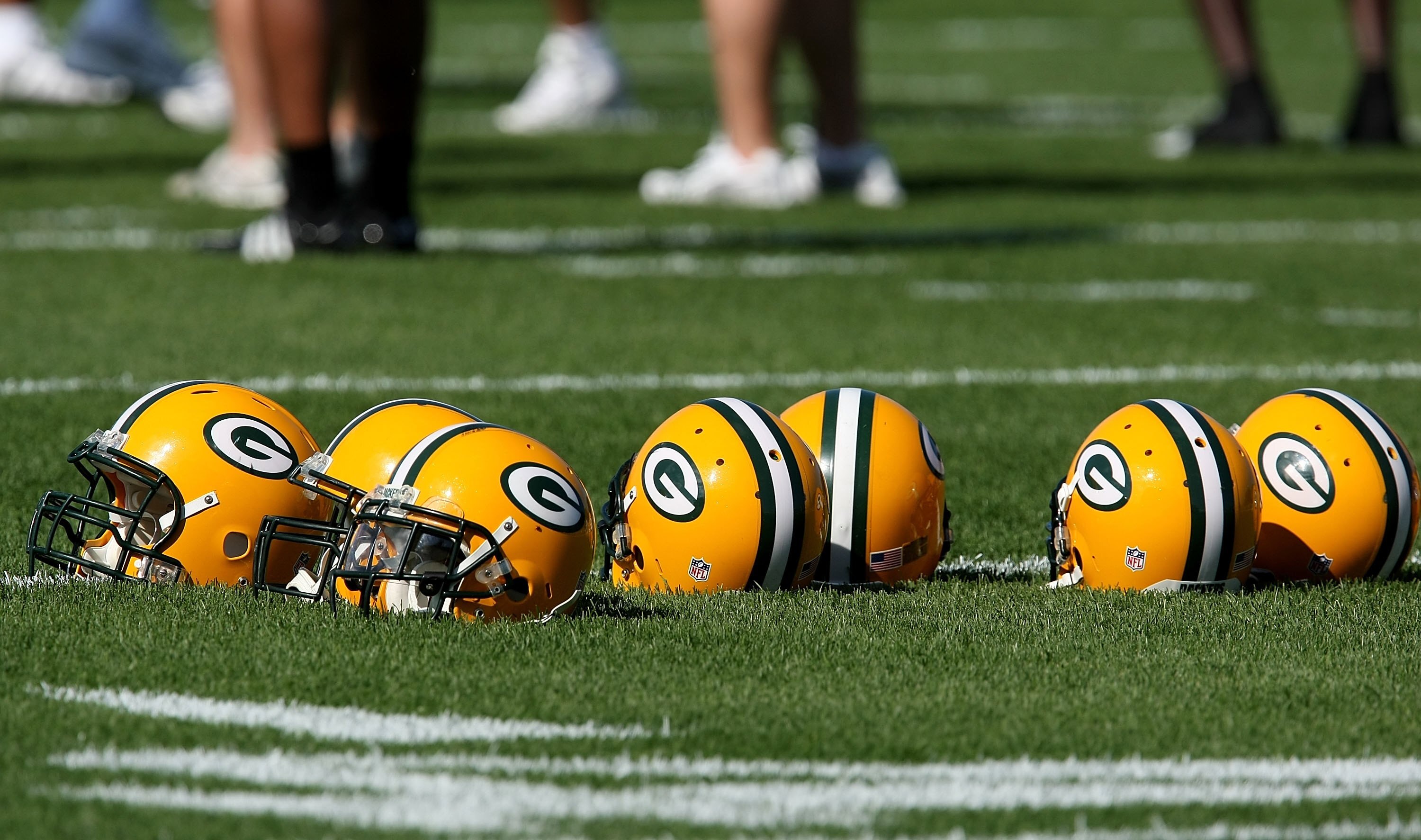 GREEN BAY, WI - JULY 28: Helmuts from Green Bay Packer defensive players sit on the field during a summer training camp practice on July 28, 2008 at the Hutson Center in Green Bay, Wisconsin. (Photo by Jonathan Daniel/Getty Images)