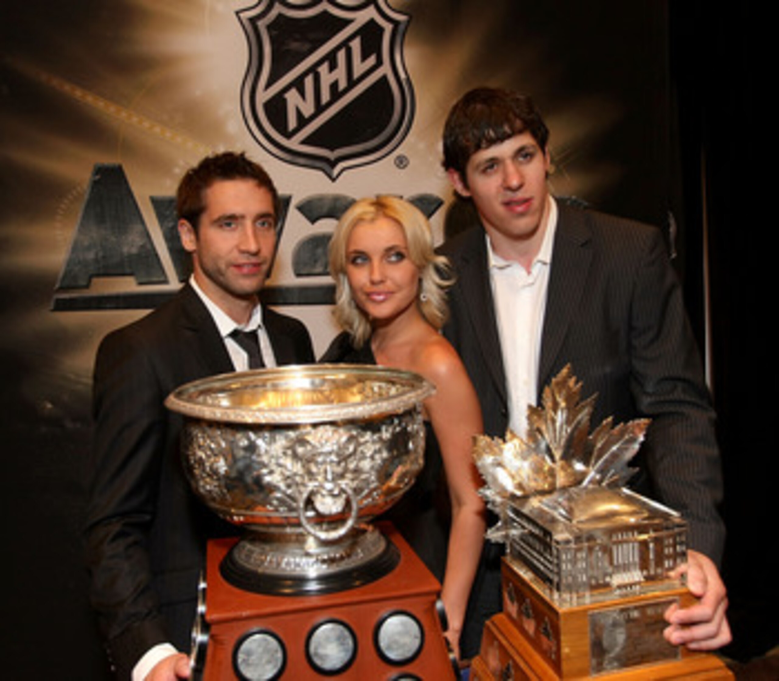 LAS VEGAS - JUNE 18:  (L-R) Max Talbot, Oxsana Kondakov and Evgeni Malkin pose with the Art Ross Trophy and the Conn Smythe Trophy following the 2009 NHL Awards at the Palms Casino Resort on June 18, 2009 in Las Vegas, Nevada.  (Photo by Bruce Bennett/Get