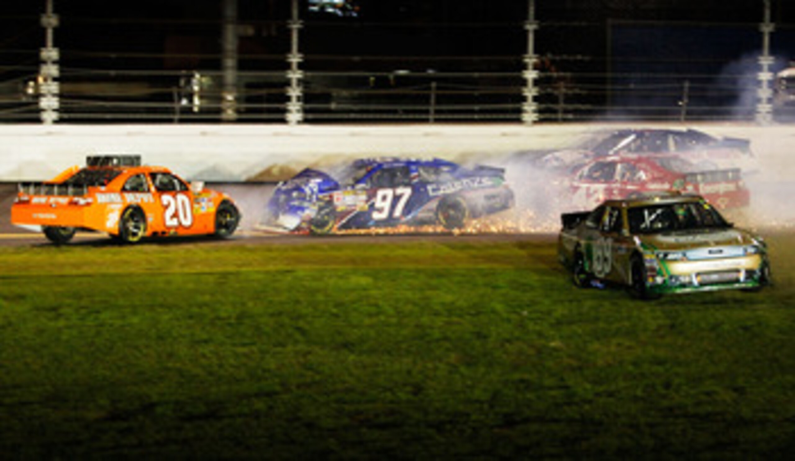 DAYTONA BEACH, FL - FEBRUARY 12:  Carl Edwards, driver of the #99 Scotts Ford, drives through the grass after crashing with Joey Logano, driver of the #20 Home Depot Toyota, Juan Pablo Montoya, driver of the #42 Target Chevrolet, and Kevin Conway, driver