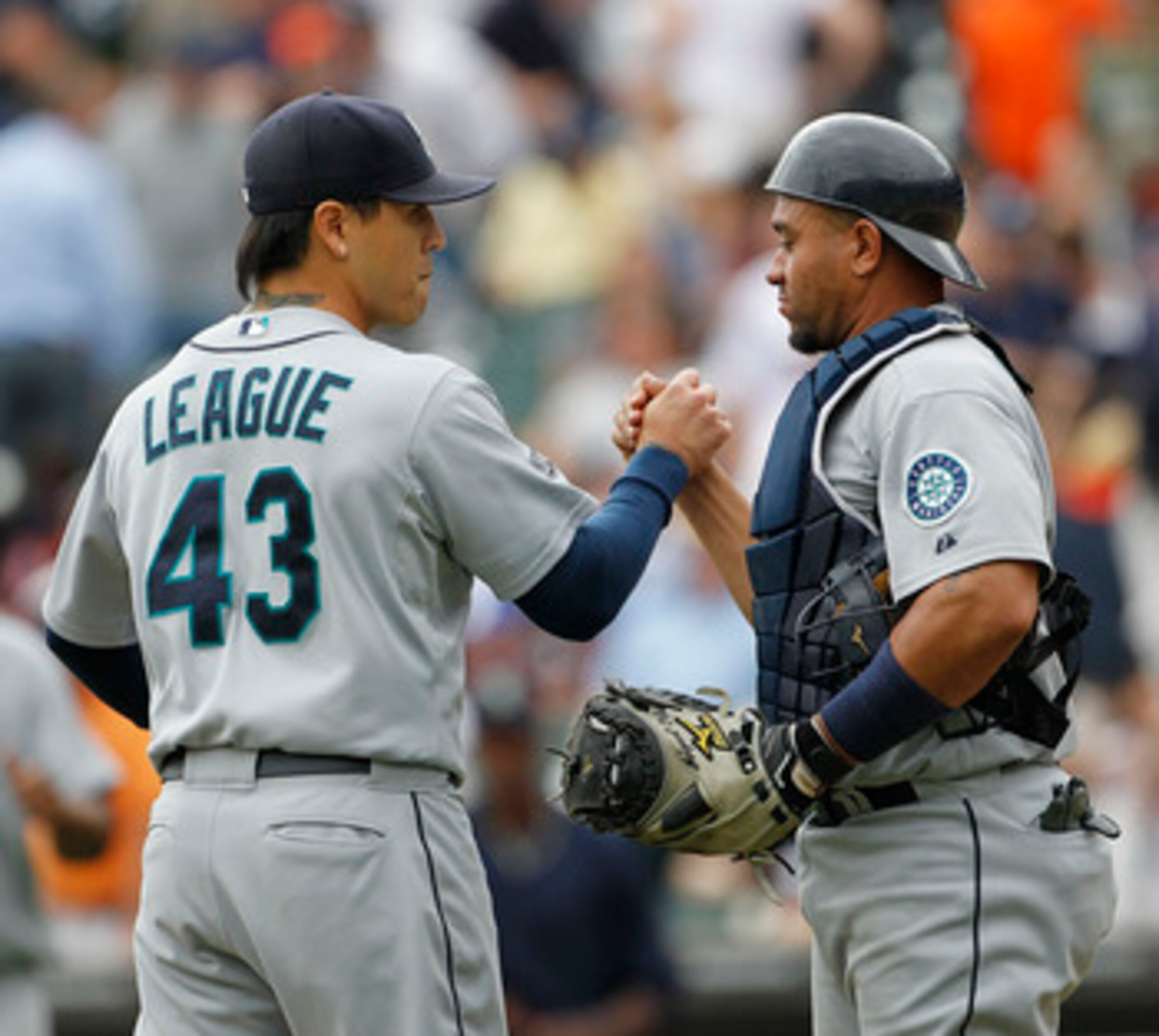 DETROIT - JUNE 12: Brandon League #43 and Miguel Olivo #30 of the Seattle Mariners celebrate a 7-3 win over the Detroit Tigers at Comerica Park on June 12, 2011 in Detroit, Michigan.  (Photo by Leon Halip/Getty Images)