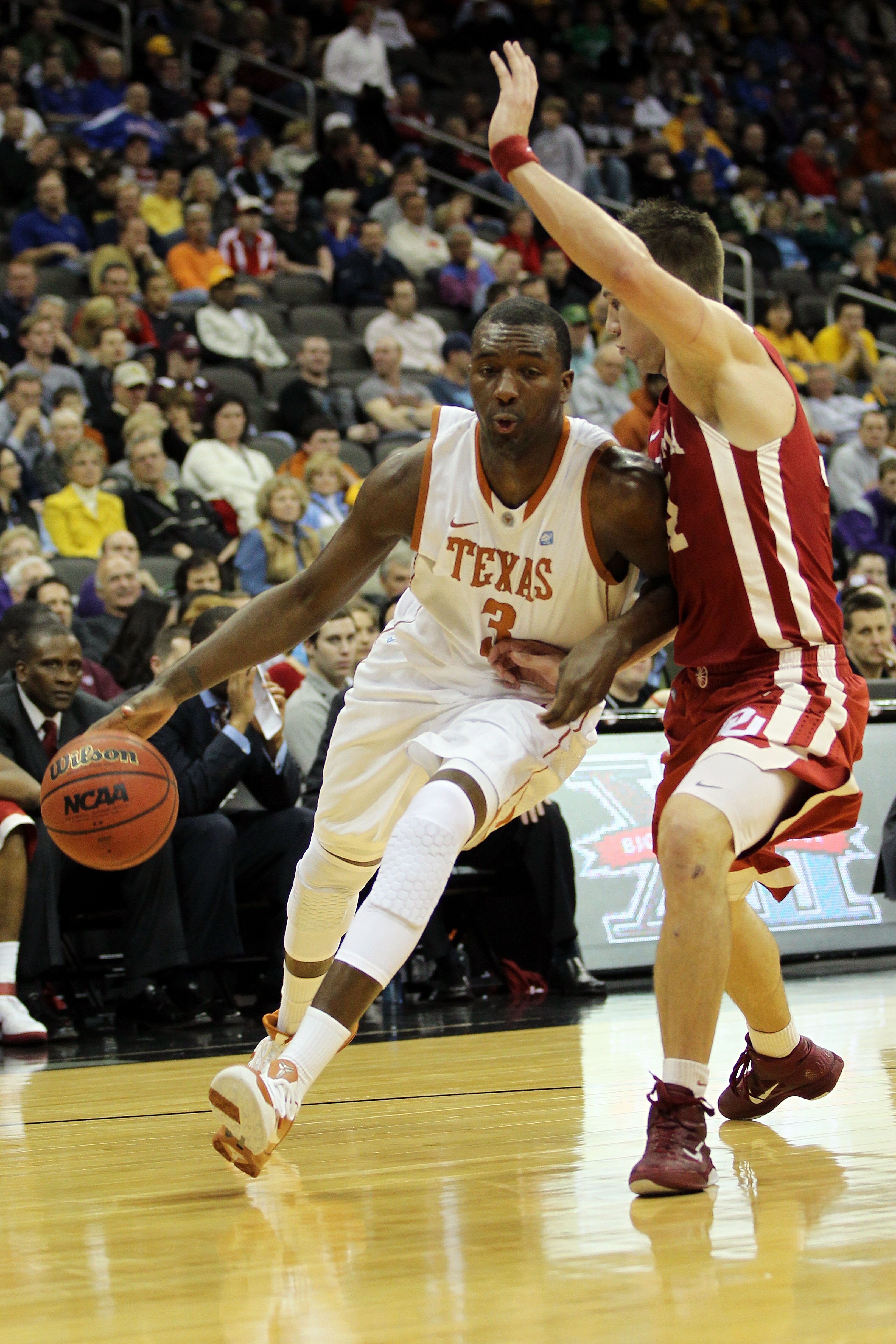 KANSAS CITY, MO - MARCH 10:  Jordan Hamilton #3 of the Texas Longhorns drives to the hoop against Cade Davis #34 of the Oklahoma Sooners during their quarterfinal game in the 2011 Phillips 66 Big 12 Men's Basketball Tournament at Sprint Center on March 10