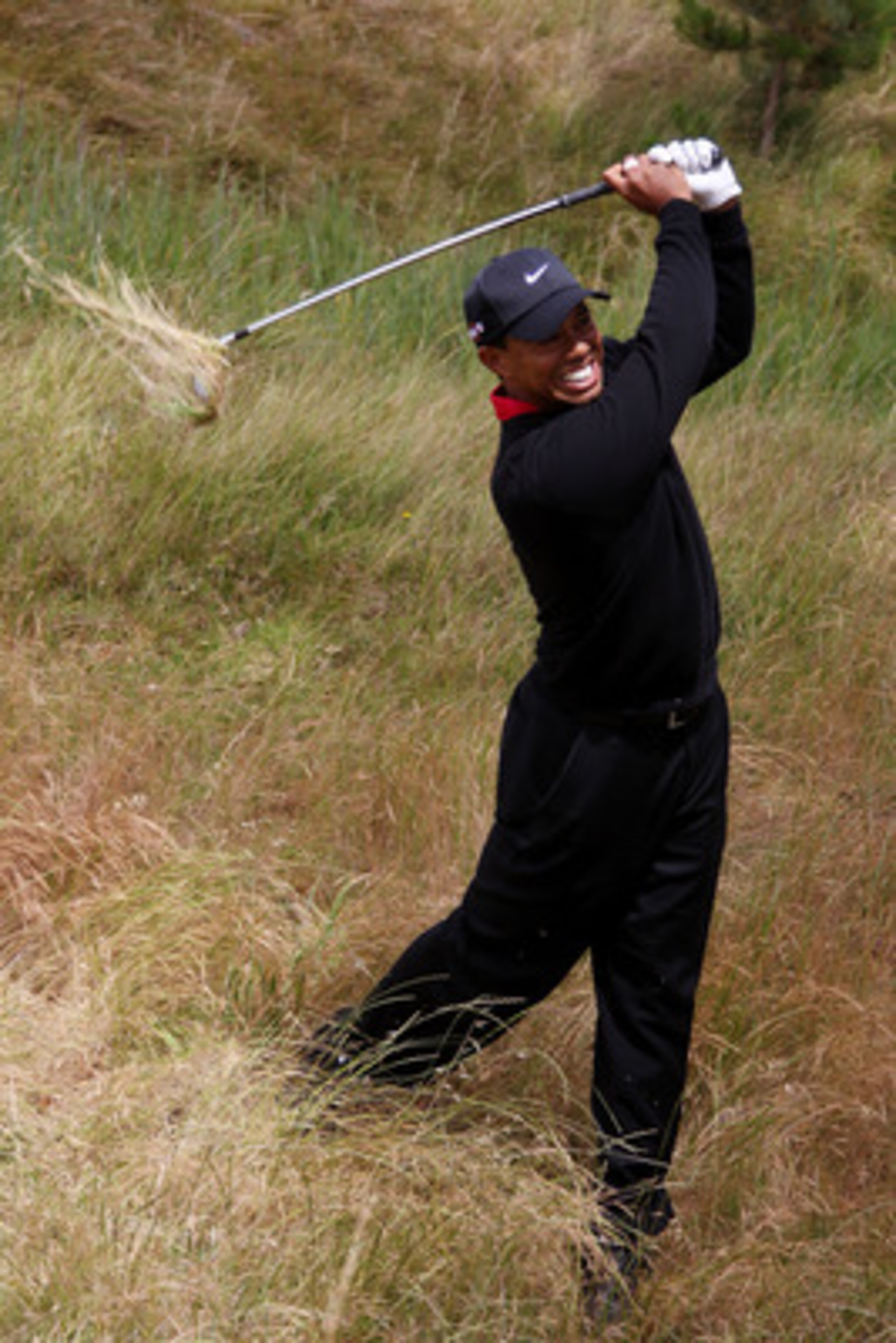 PEBBLE BEACH, CA - JUNE 20:  Tiger Woods plays a shot from the rough on the third hole during the final round of the 110th U.S. Open at Pebble Beach Golf Links on June 20, 2010 in Pebble Beach, California.  (Photo by Donald Miralle/Getty Images)