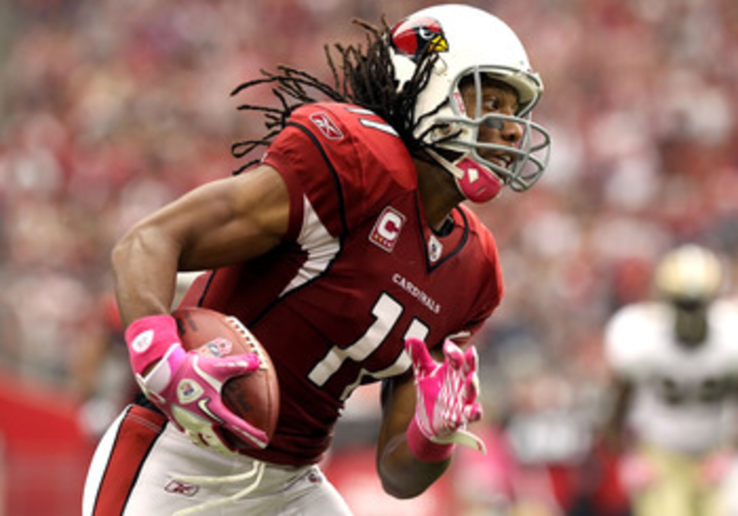 GLENDALE, AZ - OCTOBER 10:  Wide receiver Larry Fitzgerald #11 of the Arizona Cardinals runs with the football after a reception against the New Orleans Saints during the NFL game at the University of Phoenix Stadium on October 10, 2010 in Glendale, Arizo