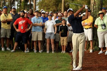 PONTE VEDRA BEACH, FL - MAY 12:  Tiger Woods hits from the rough on the first hole in front of a gallery of fans during the first round of THE PLAYERS Championship held at THE PLAYERS Stadium course at TPC Sawgrass on May 12, 2011 in Ponte Vedra Beach, Fl