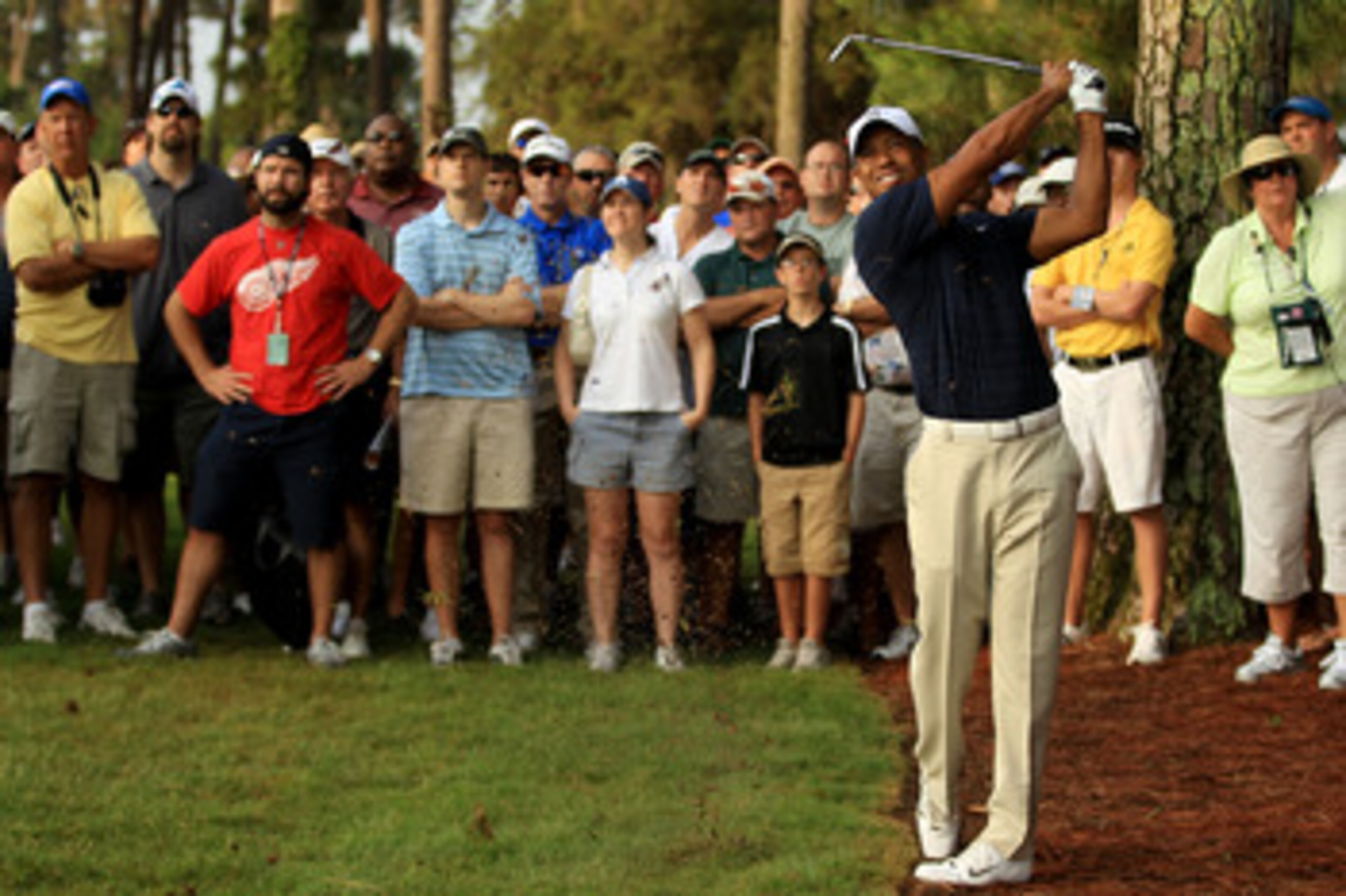 PONTE VEDRA BEACH, FL - MAY 12:  Tiger Woods hits from the rough on the first hole in front of a gallery of fans during the first round of THE PLAYERS Championship held at THE PLAYERS Stadium course at TPC Sawgrass on May 12, 2011 in Ponte Vedra Beach, Fl