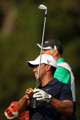 PONTE VEDRA BEACH, FL - MAY 12:  Tiger Woods hits a shot on the fifth hole as caddie Steve Williams looks on during the first round of THE PLAYERS Championship held at THE PLAYERS Stadium course at TPC Sawgrass on May 12, 2011 in Ponte Vedra Beach, Florid