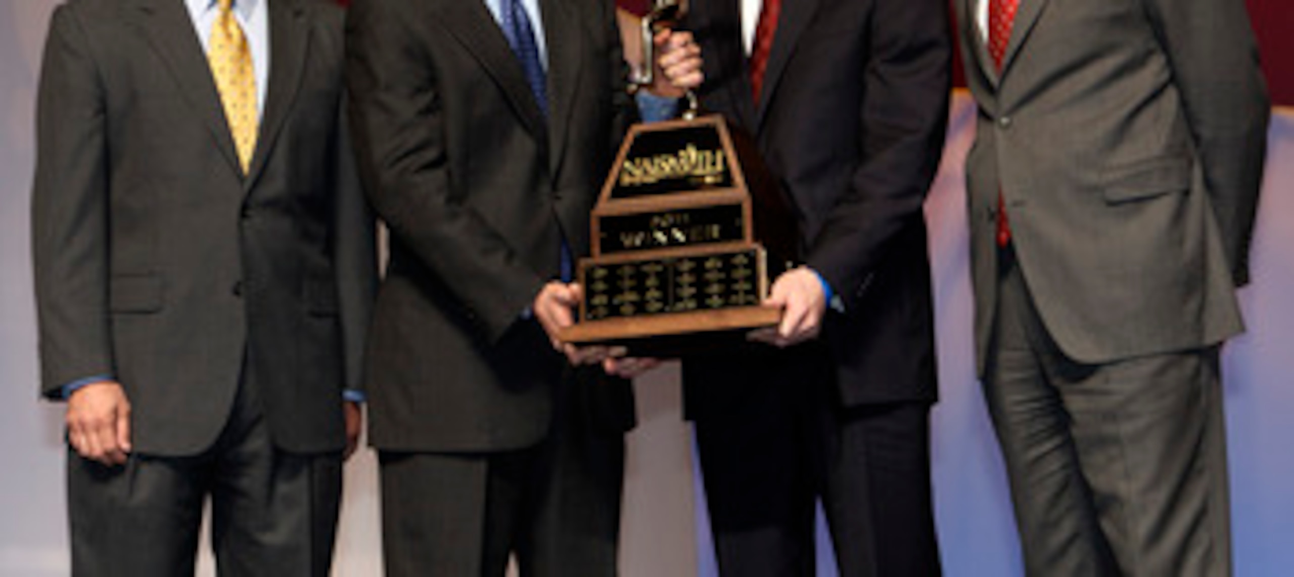 HOUSTON - APRIL 03:  Jimmer Fredette of BYU receives the 2011 Naismith Trophy Presented by AT&T from David Christopher of AT&T during the NABC Guardians of the Game Awards Program on April 3, 2011 in Houston, Texas.  Joining them on stage are Eric Oberman